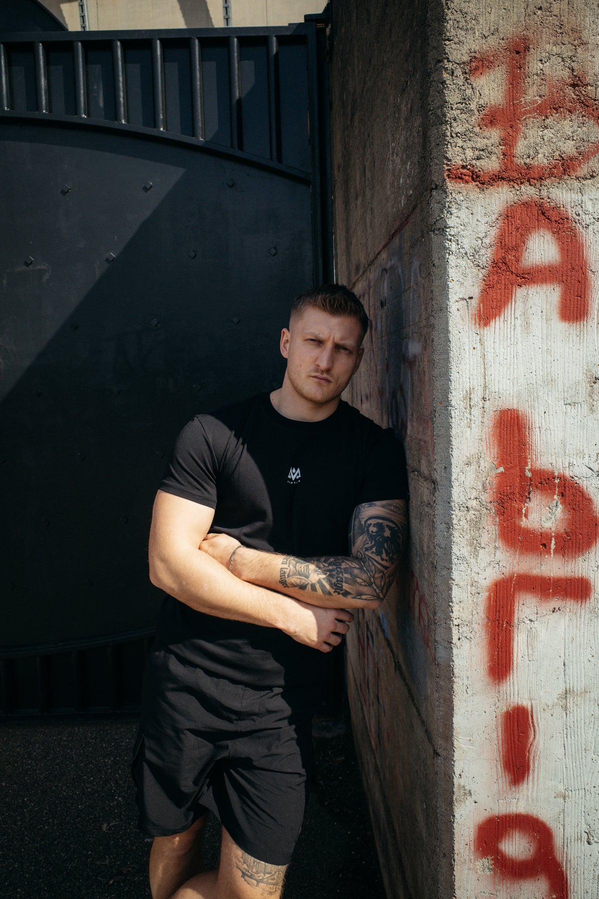 Black T-shirt with small white logo on the center chest