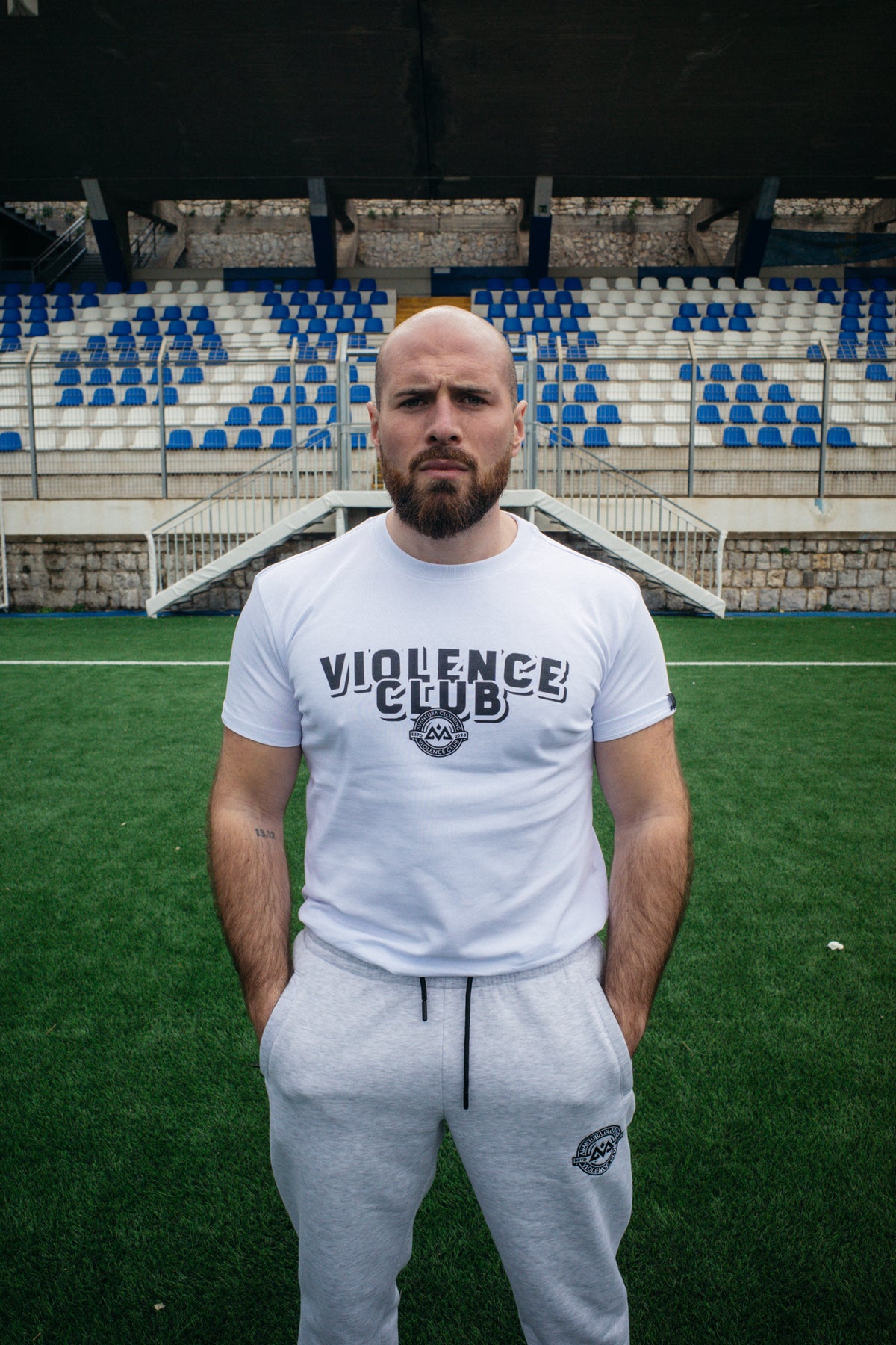 Front view of white Violence Club T-shirt showing centered logo and fit