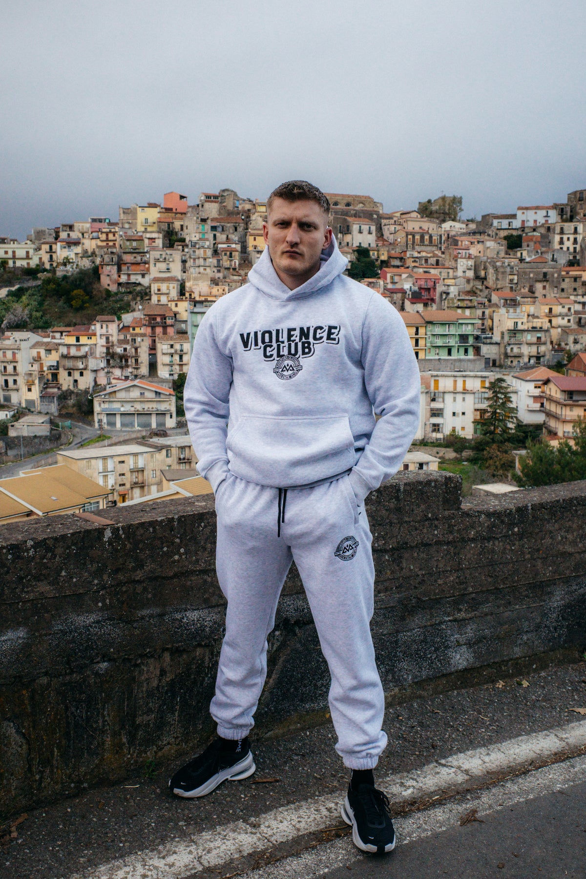 Man wearing light grey heathered Violence Jogger Bundle in outdoor urban setting