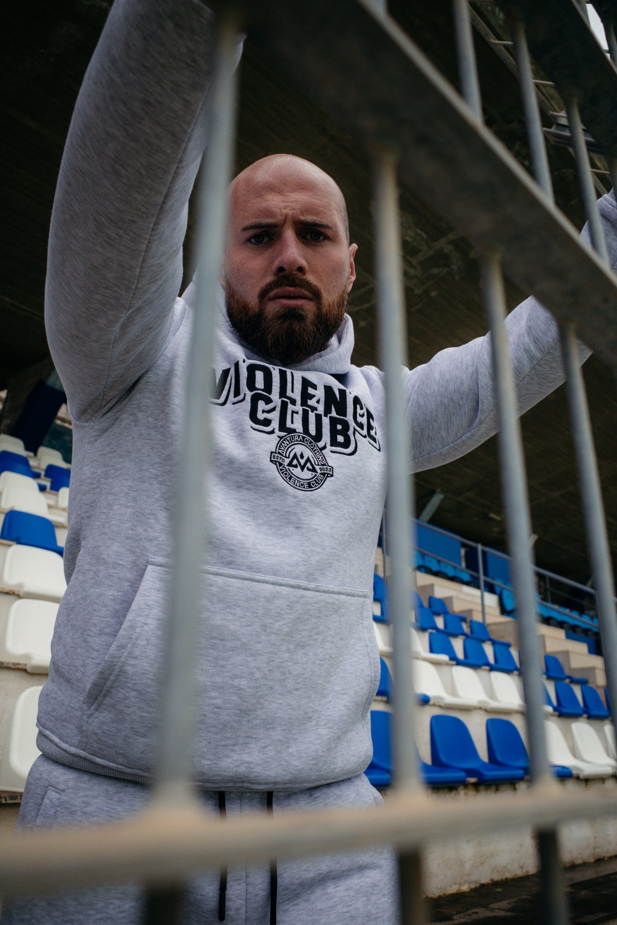 Front view of light grey heathered hoodie with black VIOLENCE CLUB chest embroidery