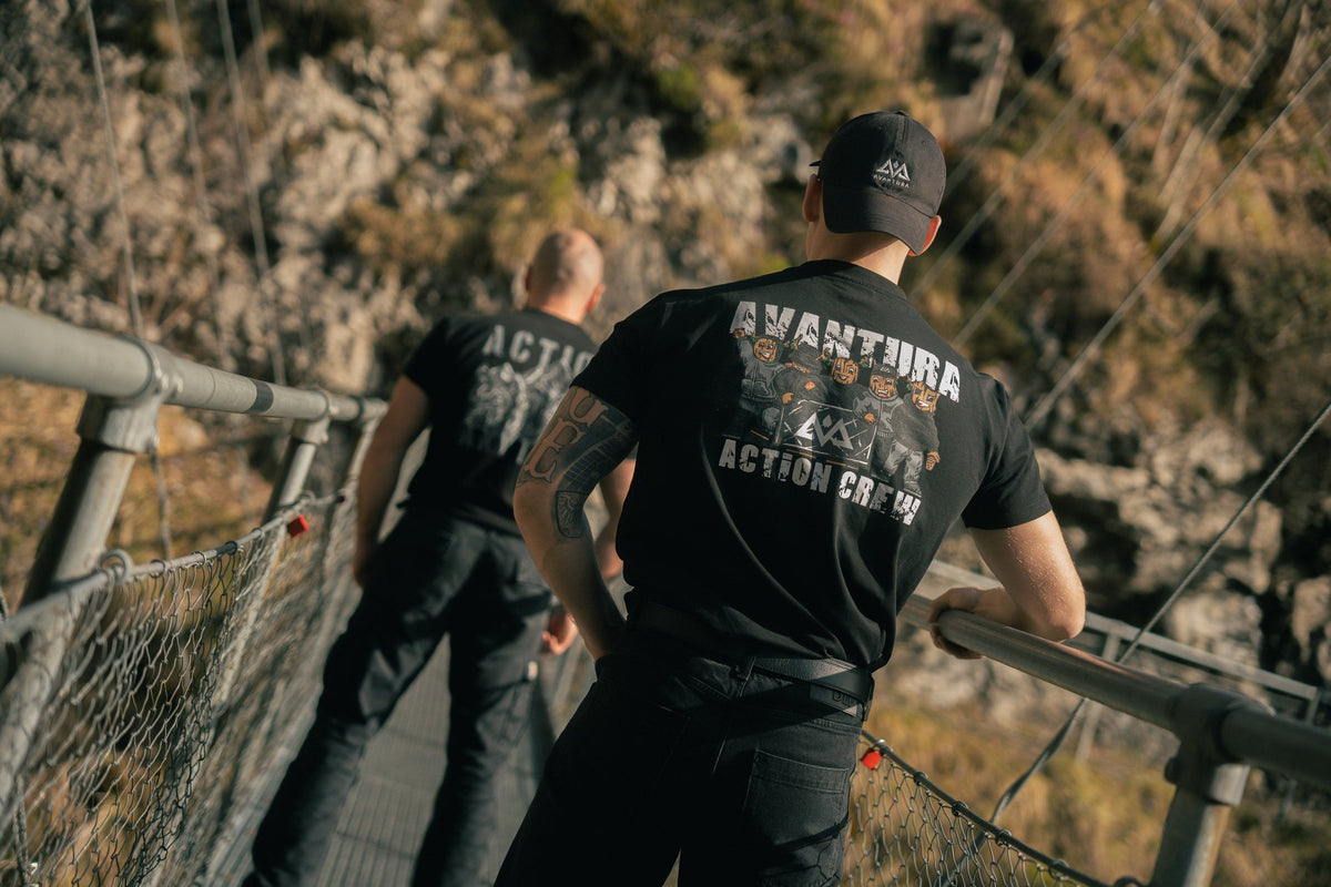 Black Action Crew T-shirt with large AVANTURA back print worn on suspension bridge