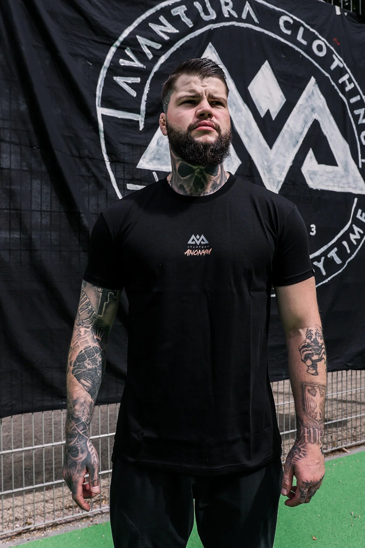 Front view of black Avantura Anonym T-shirt with geometric logo