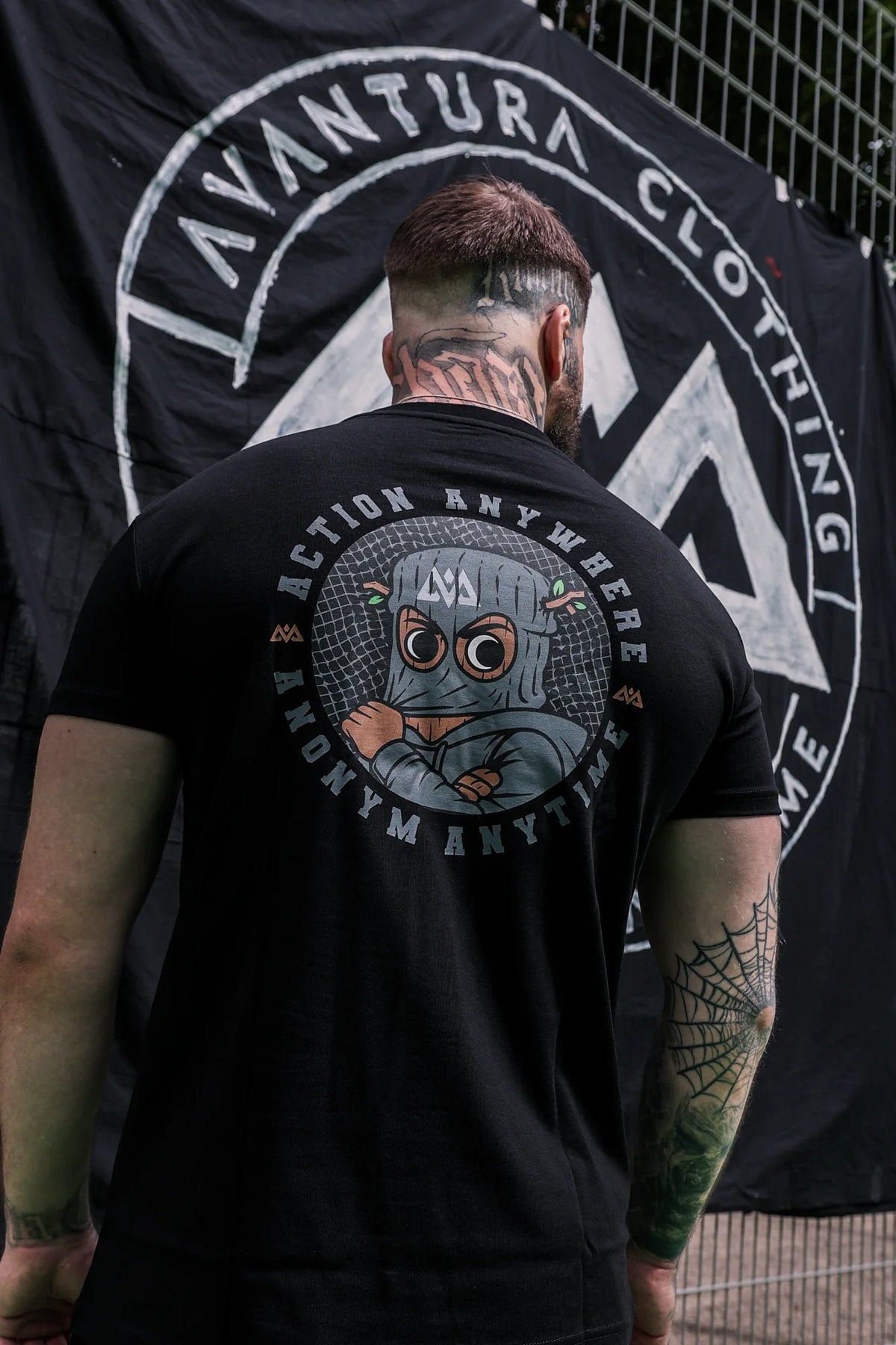 Full rear view of black T-shirt with masked character graphic