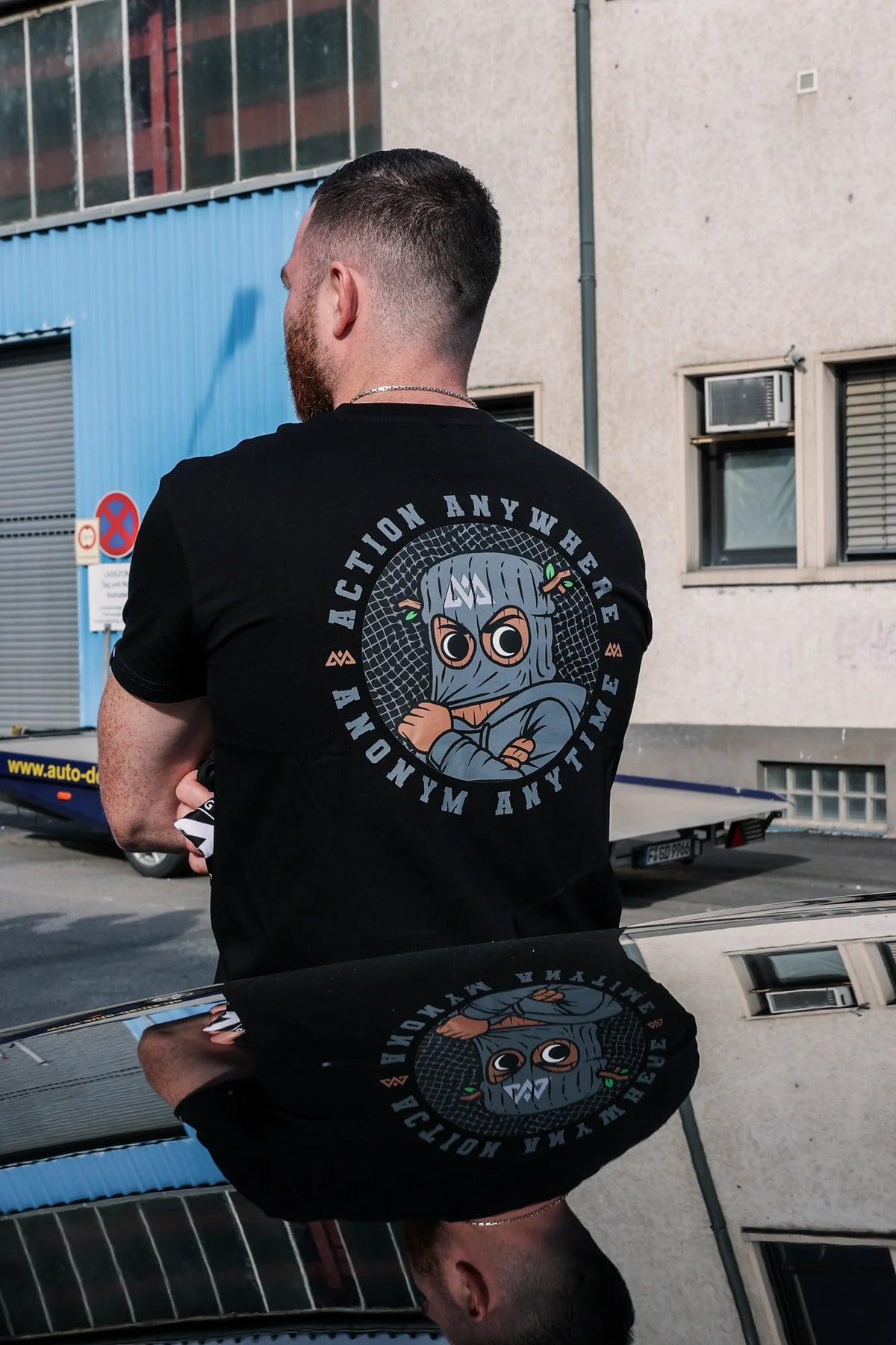 Black T-shirt featuring large circular Action Anywhere back print