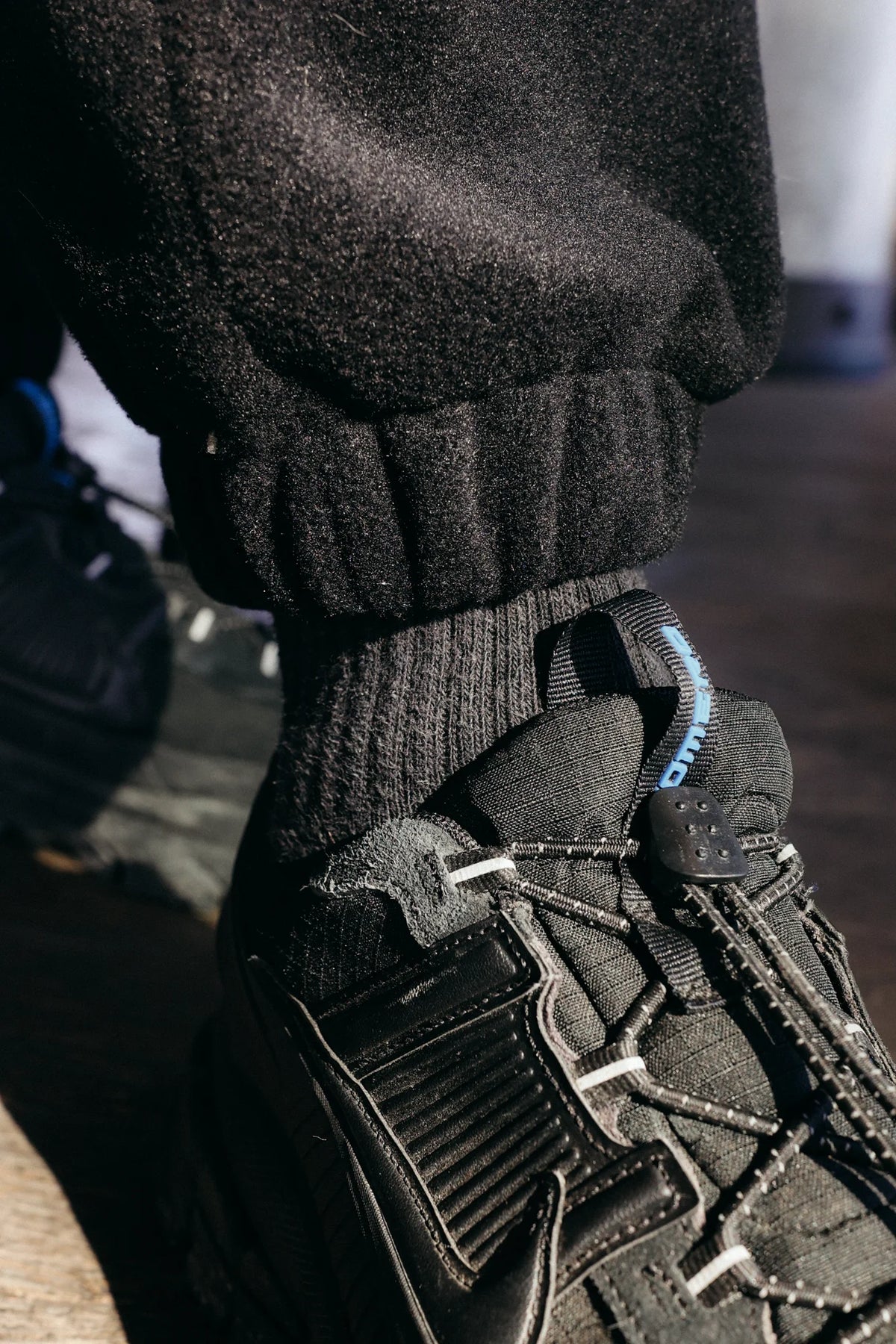 Close-up of ribbed elastic cuff on black fleece joggers