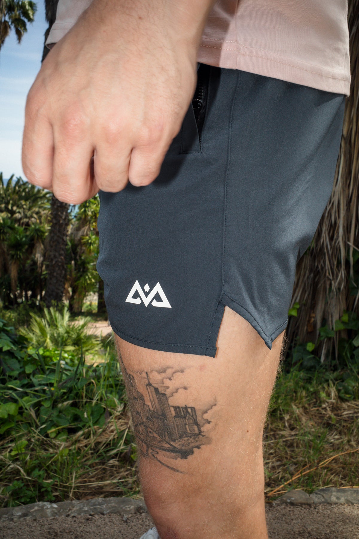 Navy blue AVA logo sport shorts side detail with zippered pocket