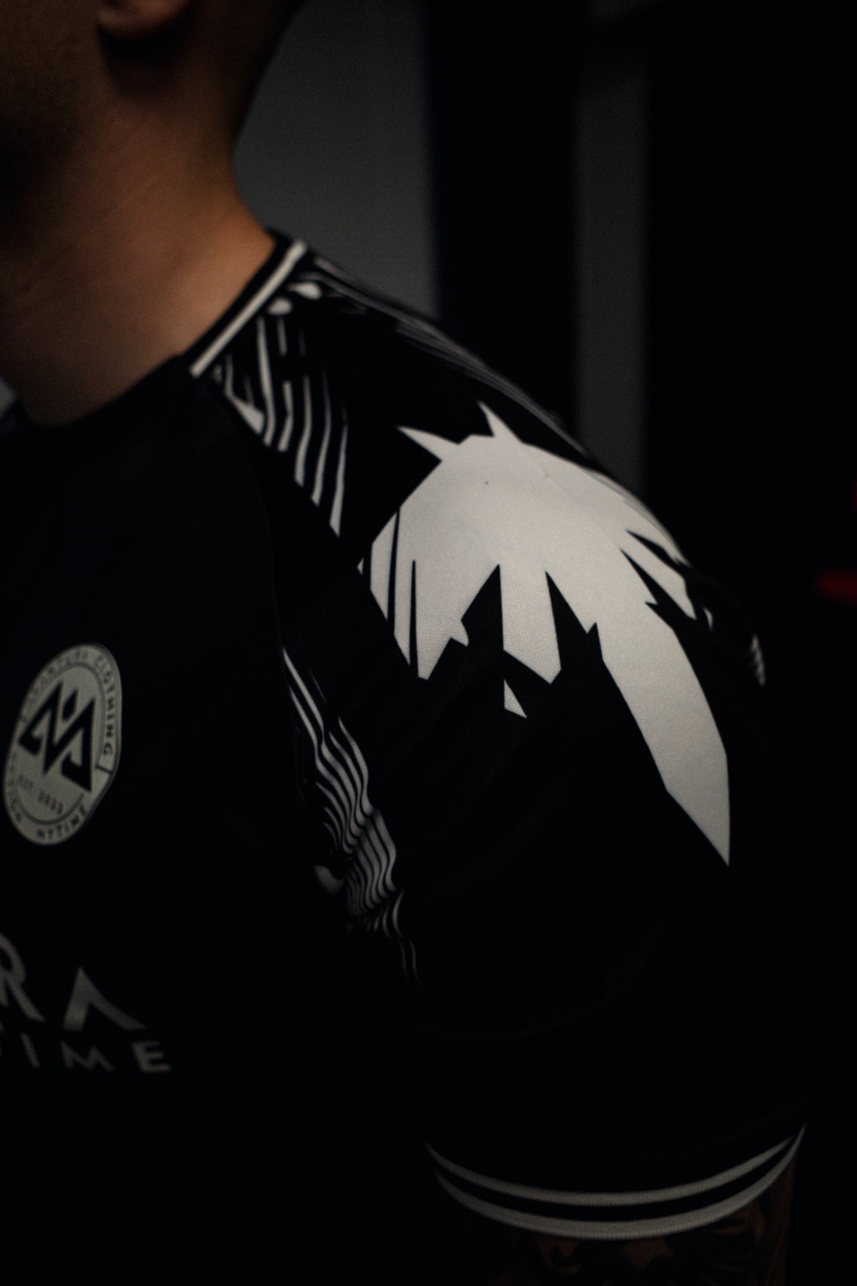 Close-up of black jersey abstract white graphic print on shoulder