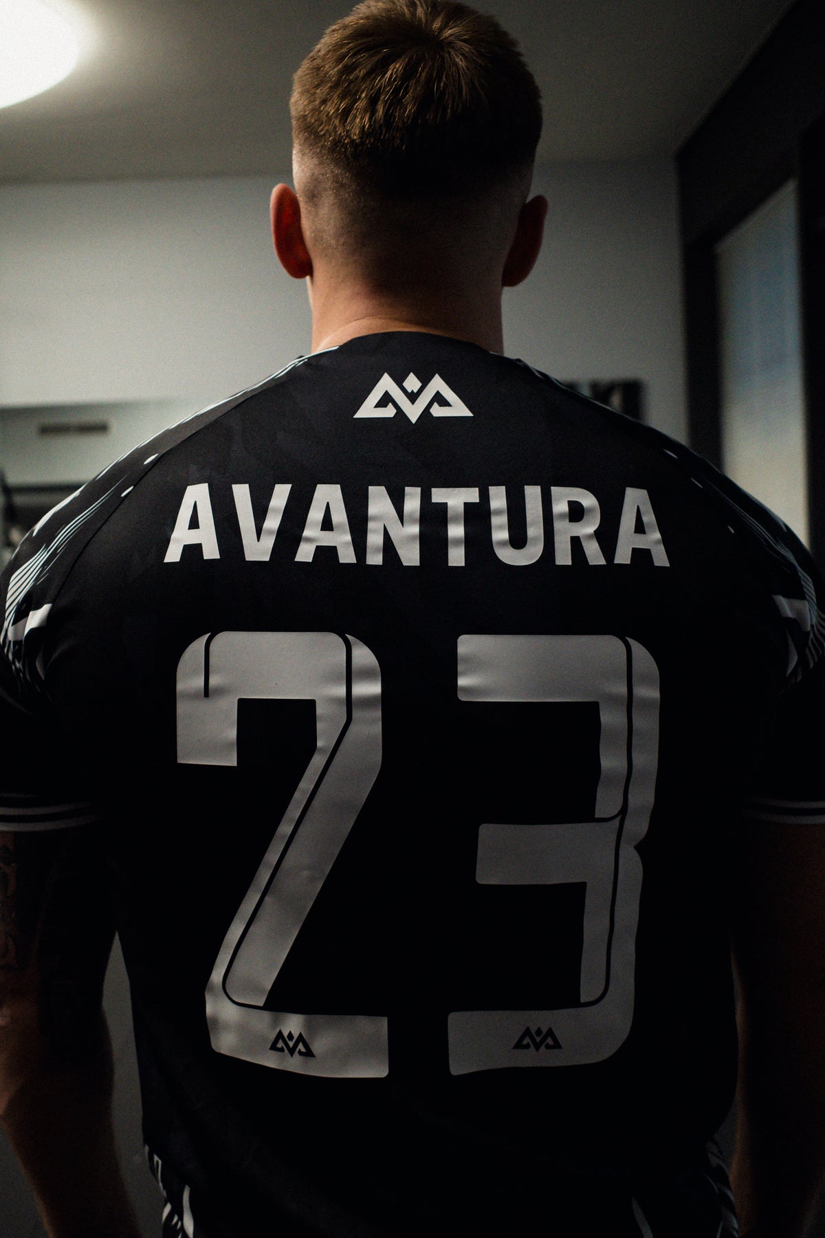 Rear view of black jersey with metallic silver number 23