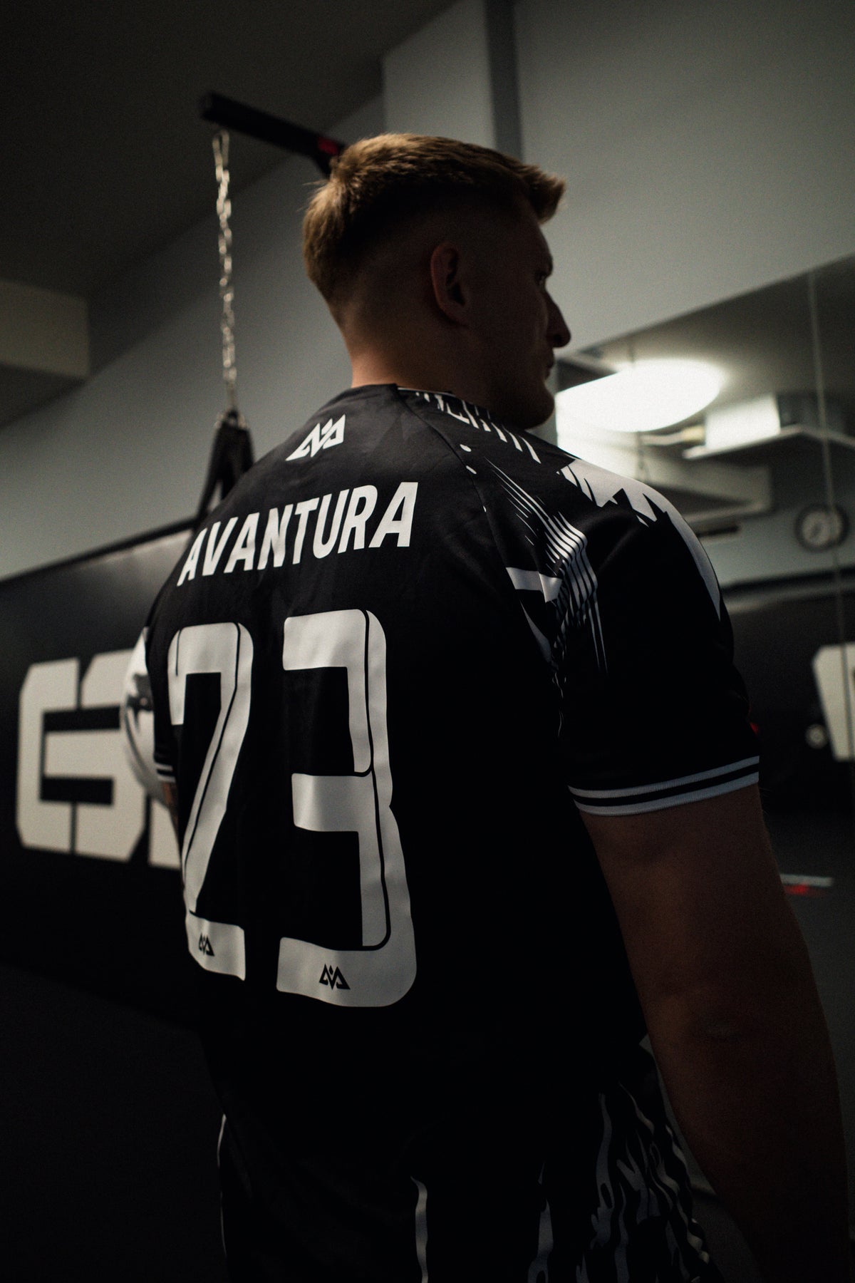 Athletic black jersey back with white number 23 and sleeve stripes