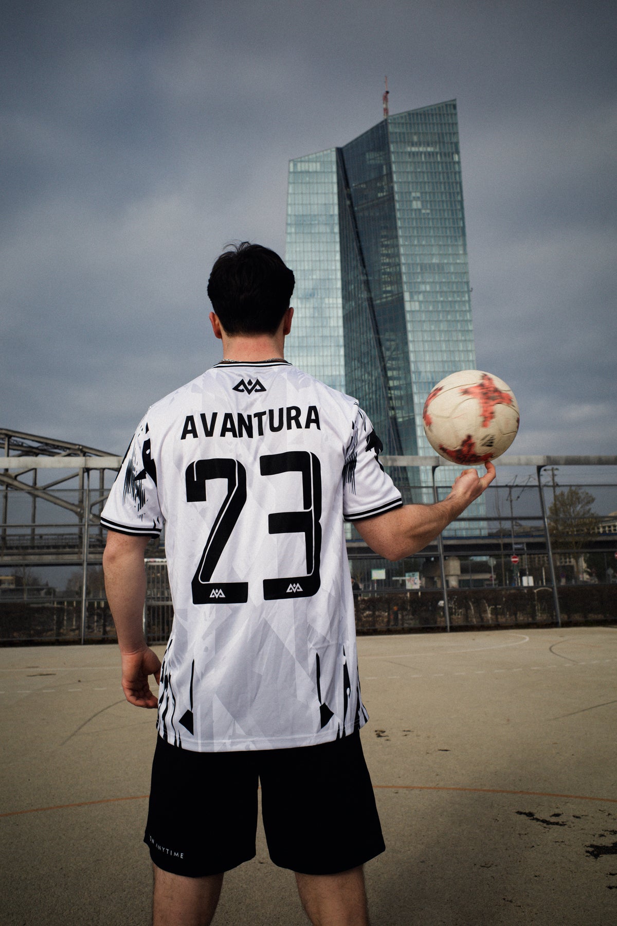 Rear view of white Avantura jersey with number 23 graphic and geometric sleeve details