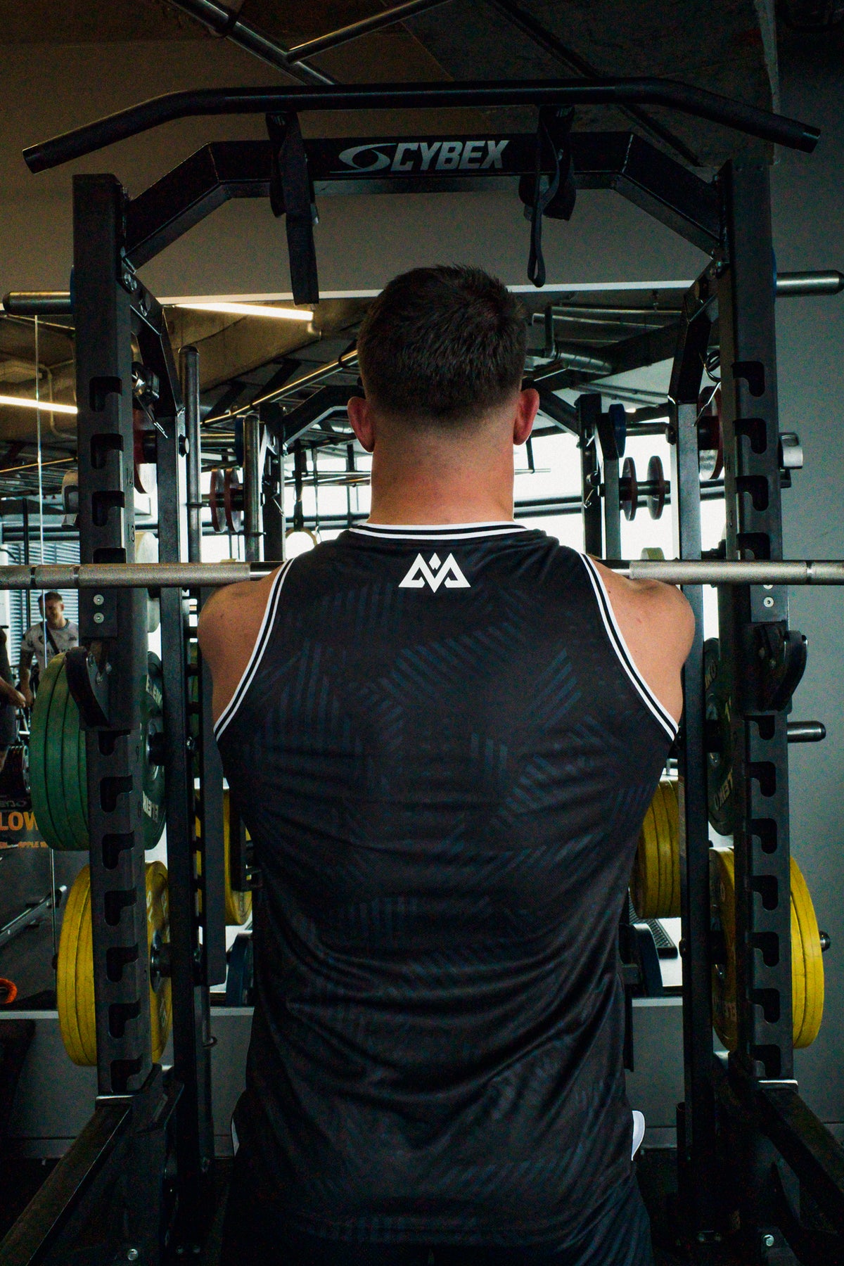 Back view of black Avantura tank top revealing subtle diagonal texture pattern