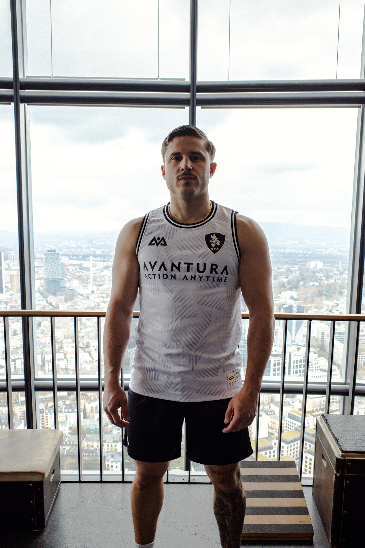 White Avantura jersey tank top with black trim and 'Action Anytime' print