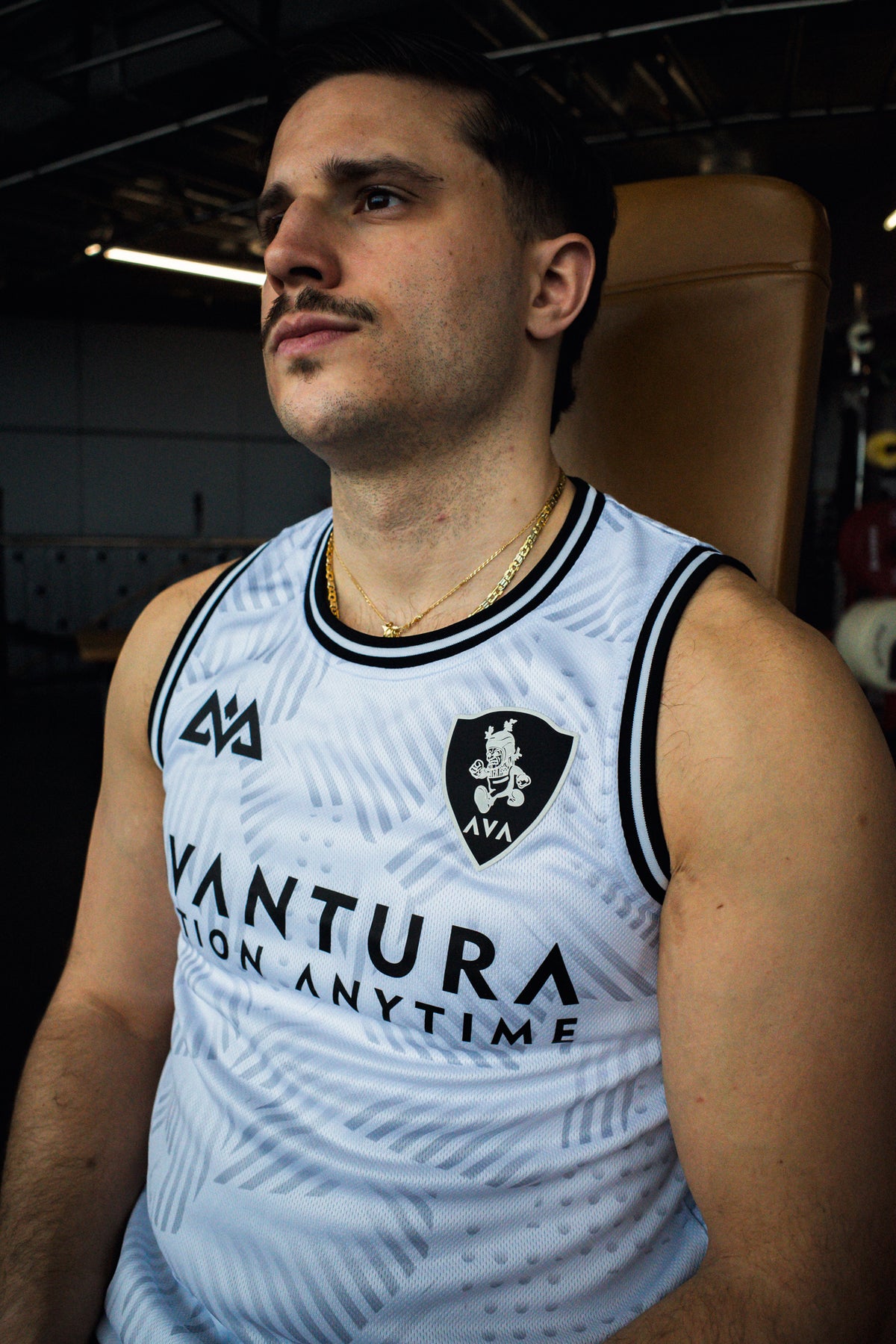 Close-up of white mesh jersey fabric texture and chest logos on tank top