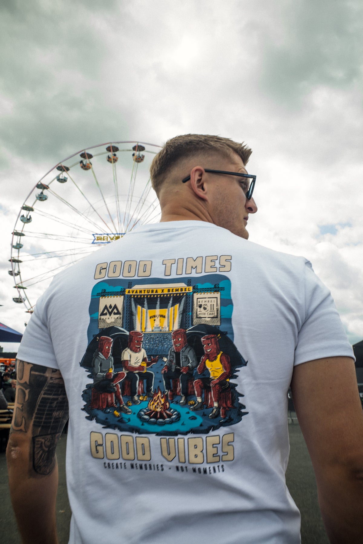 Side profile of man in white t-shirt showing colorful back graphic
