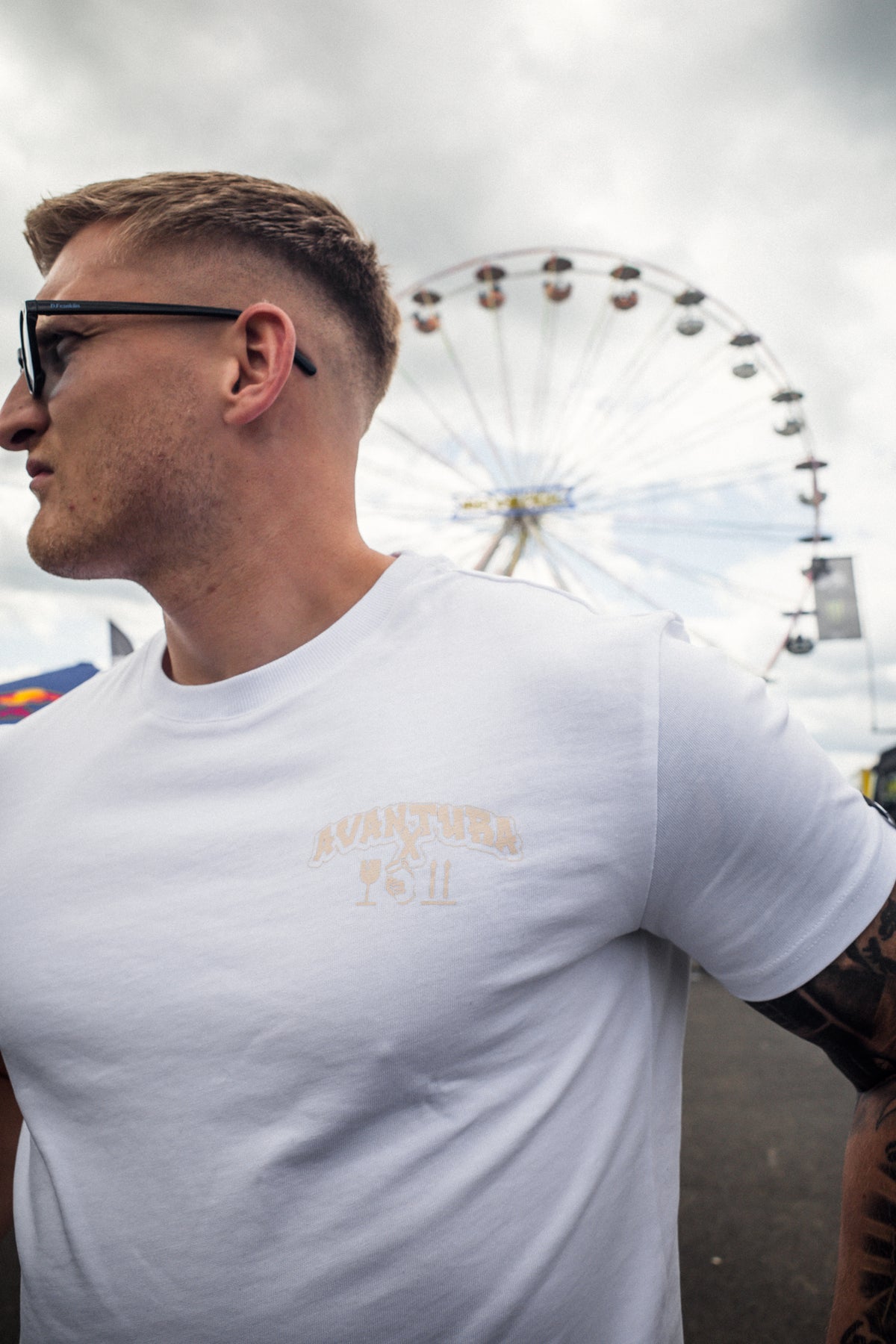 Profile shot of white crew neck t-shirt with small left chest logo