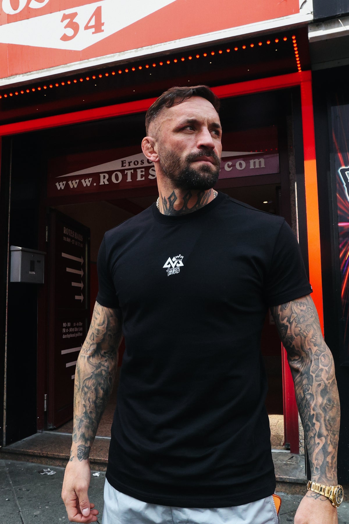 Black Avantura t-shirt with small white geometric AVX logo on chest