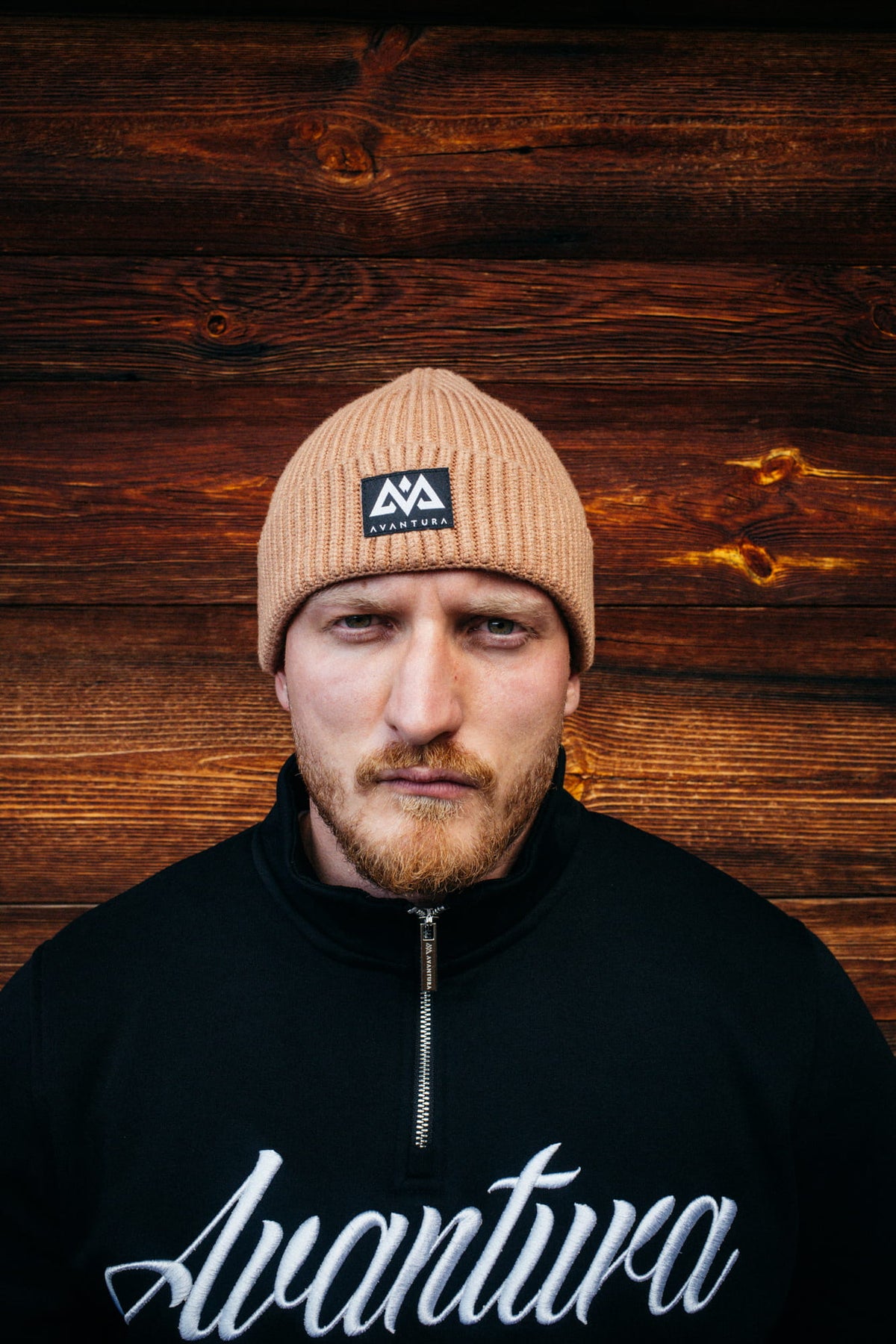 Beige Avantura Beanie mit gerippter Struktur und schwarzem Patch-Logo