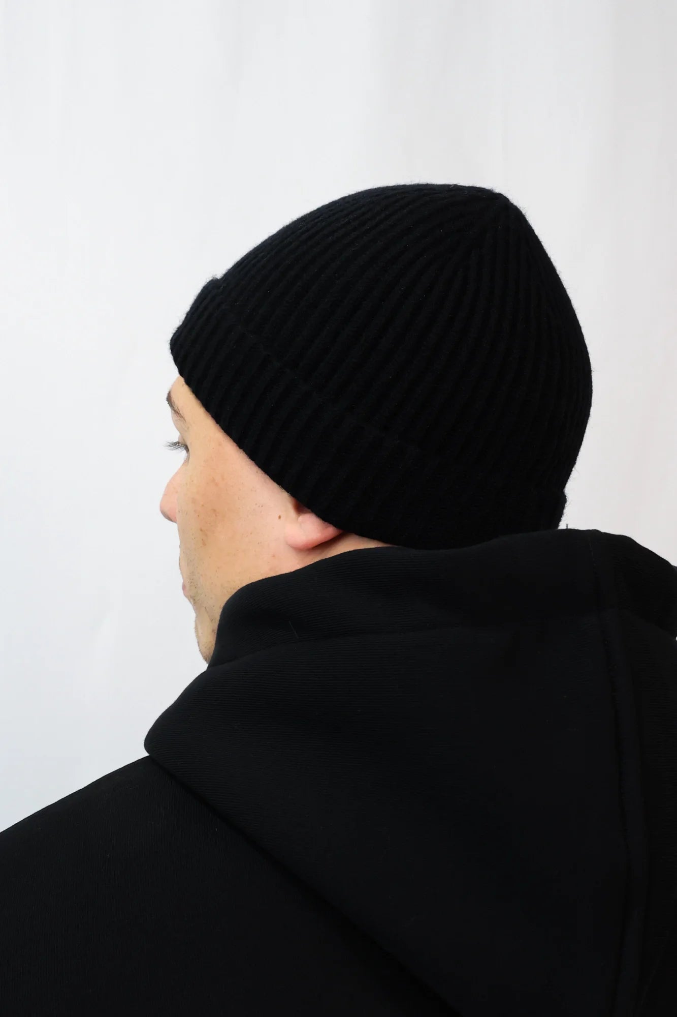 Back view of ribbed knit black beanie