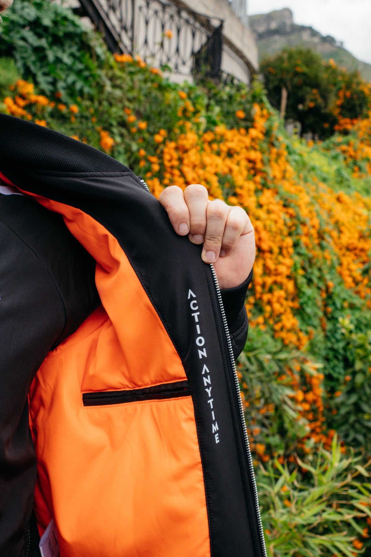 Orange lining and internal pocket of black bomber jacket
