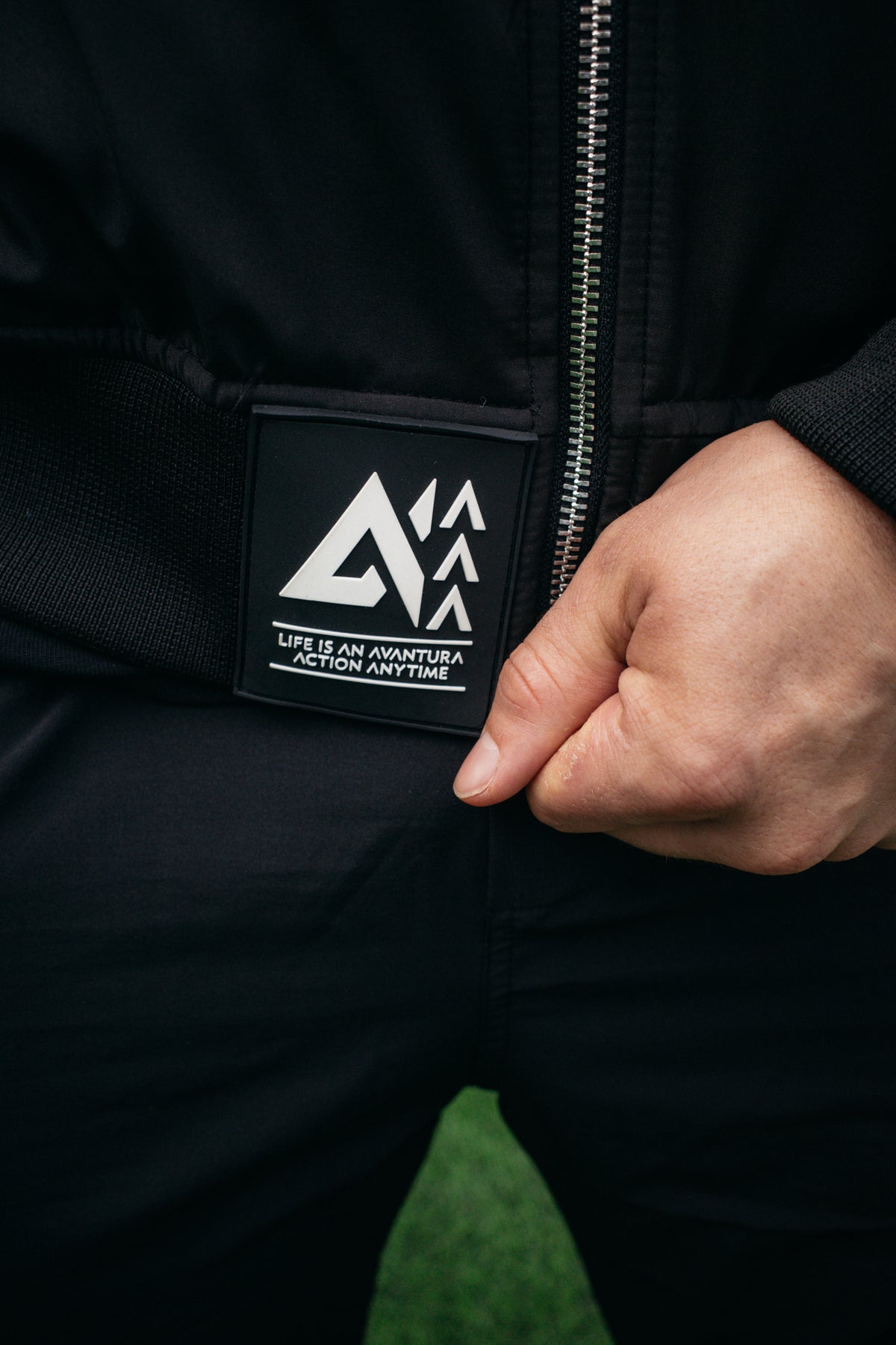 Black bomber jacket rubber label detail at hem