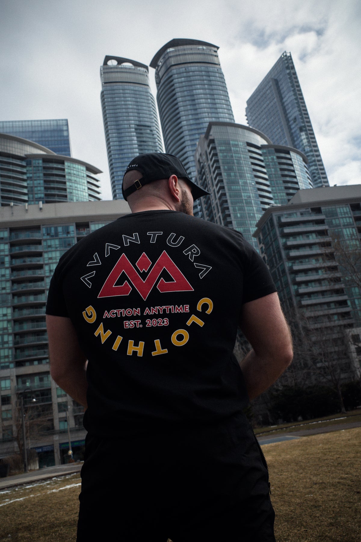 Black classic logo Deutschland T-shirt with large circular back print featuring red mountain logo and AVANTURA CLOTHING text