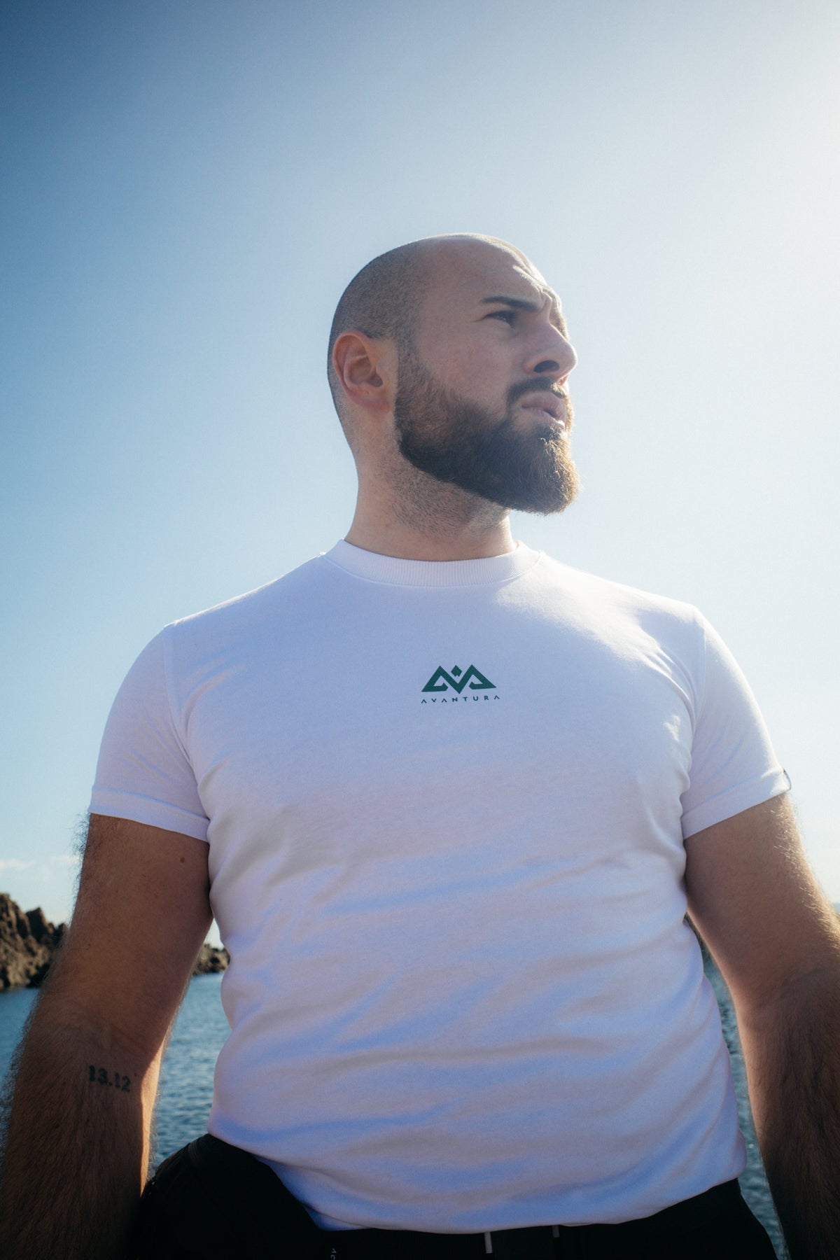 White crew neck t-shirt with small centered chest logo