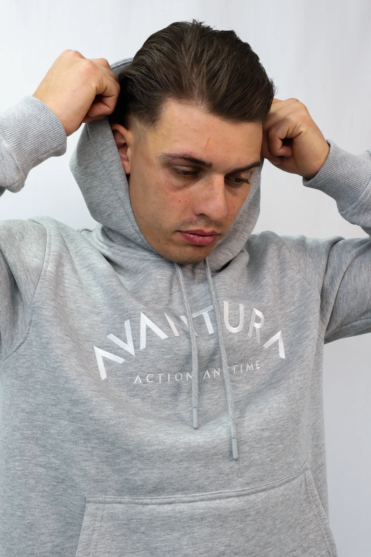 Grey Avantura hoodie with curved white logo and kangaroo pocket