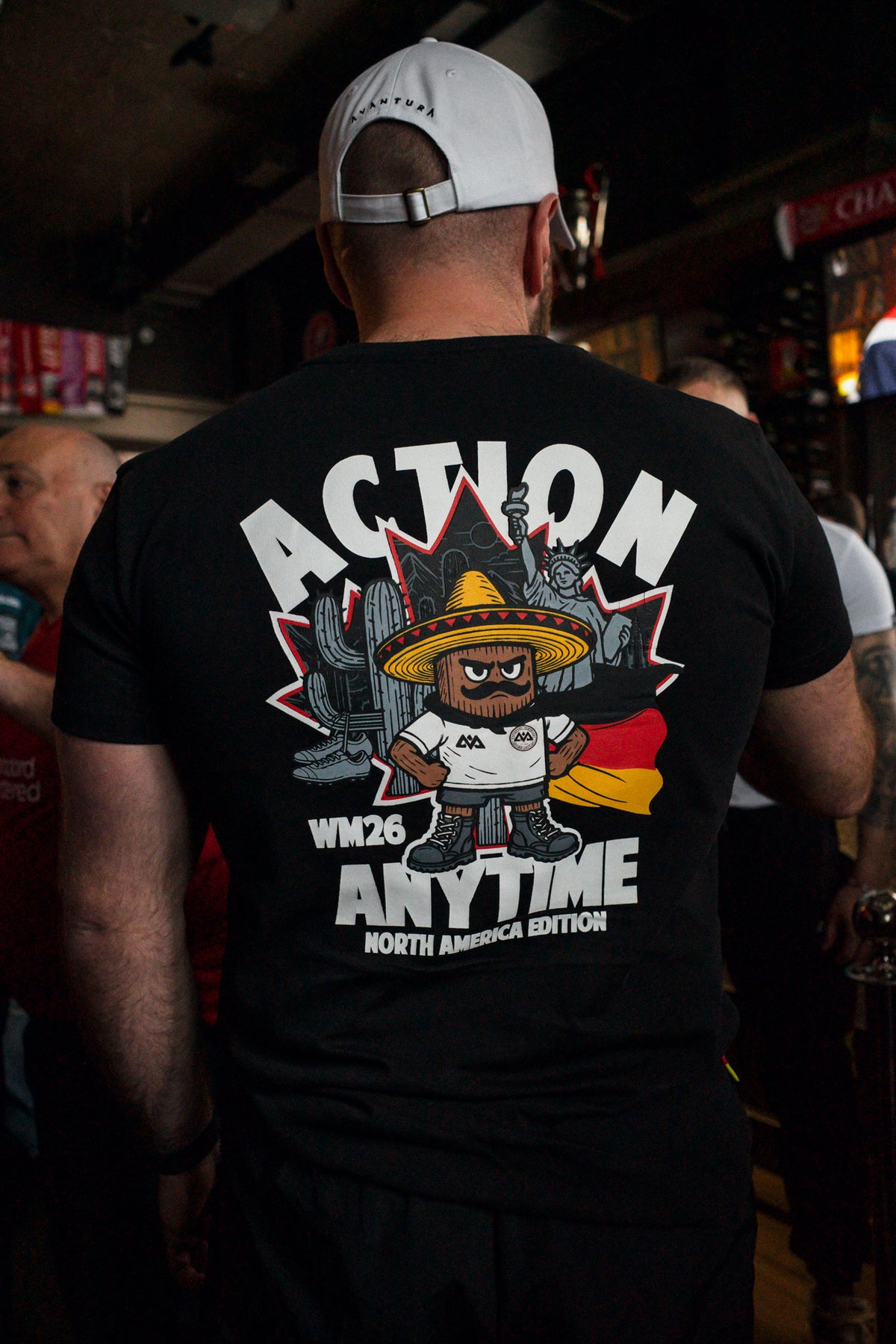 Detailed view of black T-shirt back graphic with cartoon character and flag