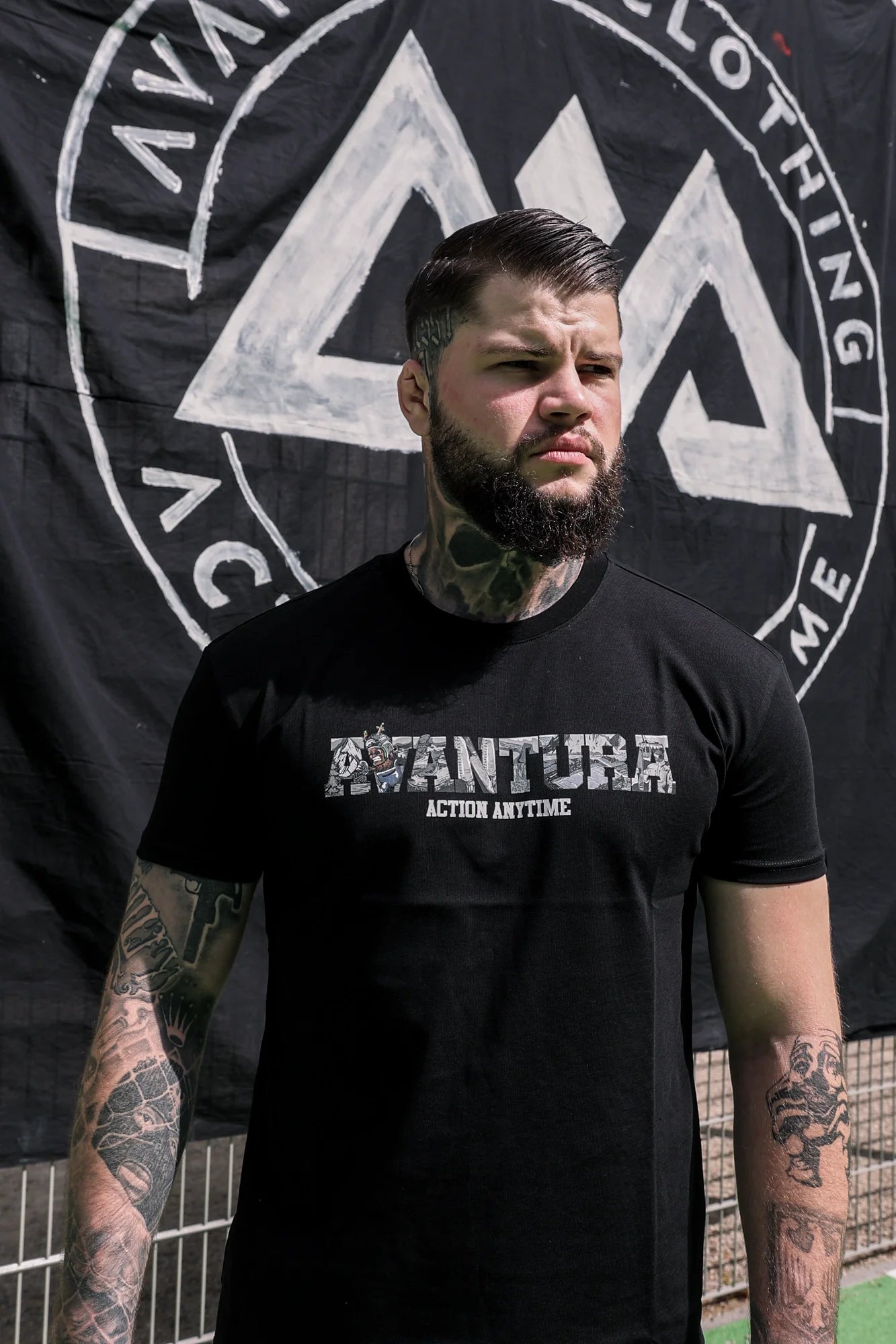 Front view of black crew-neck T-shirt featuring bold white 'AVANTURA' logo print