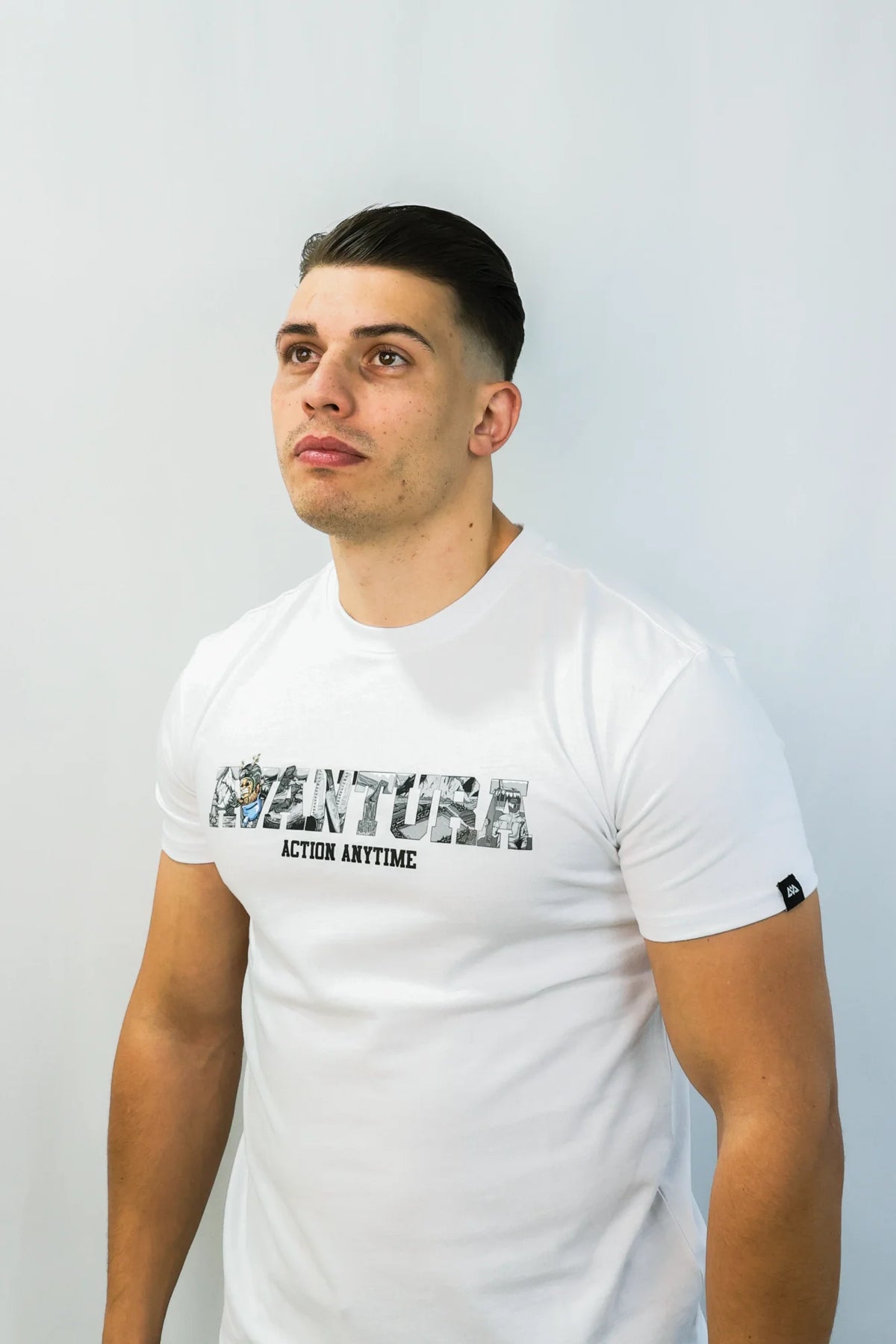 Male model wearing fitted white Avantura T-shirt with chest graphic print