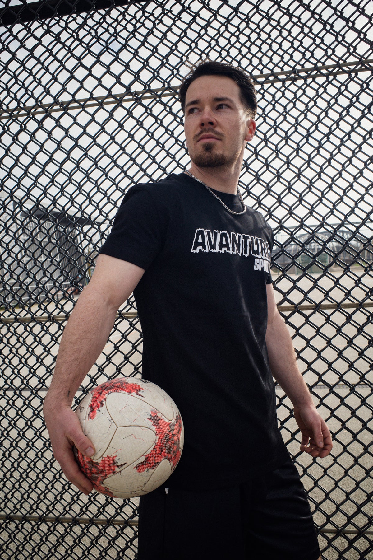 Black crew neck T-shirt with rugged eroded 'Avantaura Sports' chest typography
