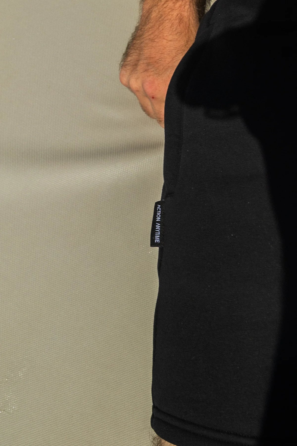Black shorts side seam woven label close-up