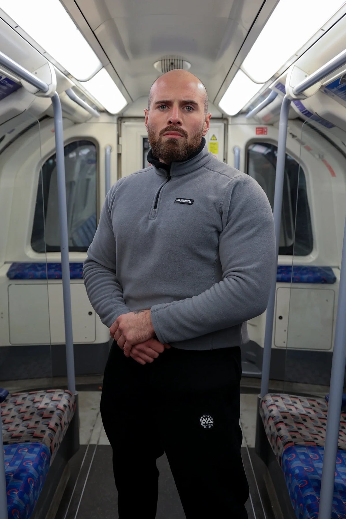 Front view of grey halfzip fleece sweater with black zipper track and small brand patch