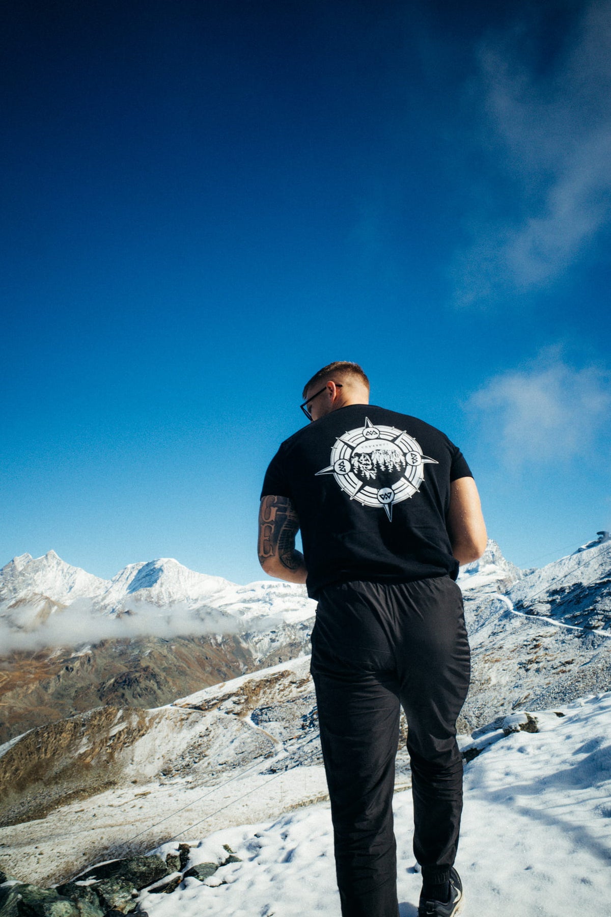 Black T-shirt with large white back print worn in snow