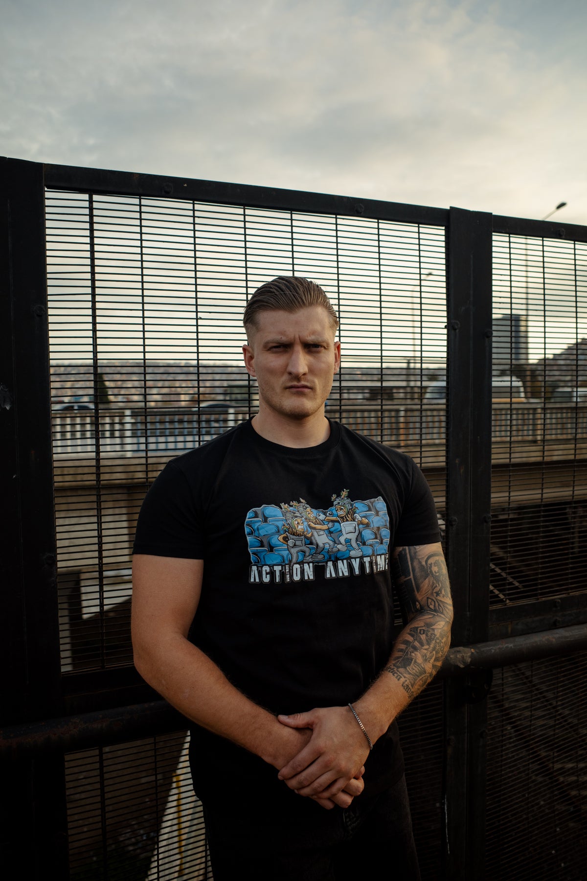 Front view of black t-shirt featuring Action Anytime chest illustration