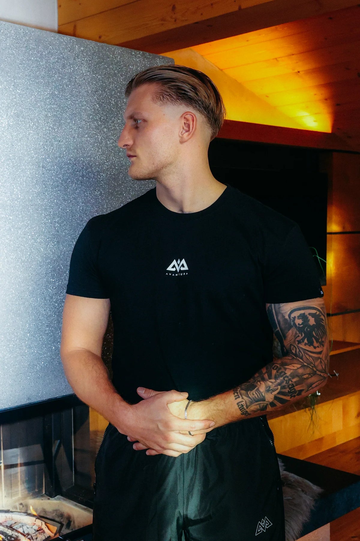 Black Avantura crew neck t-shirt featuring small white geometric mountain logo on chest