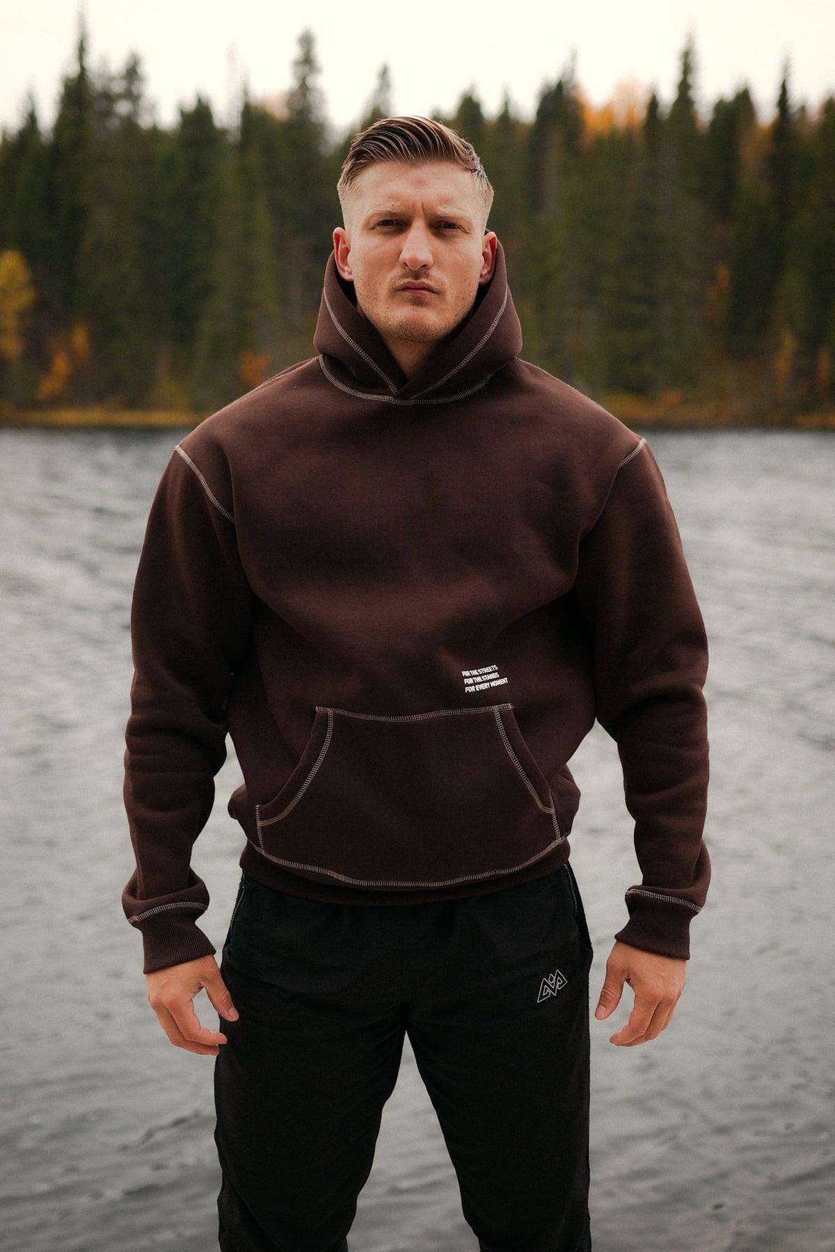 Front view of brown hoodie with kangaroo pocket and white chest print