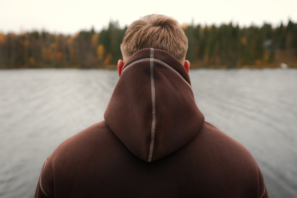 Close-up of hood back with vertical contrast seam on the brown hoodie