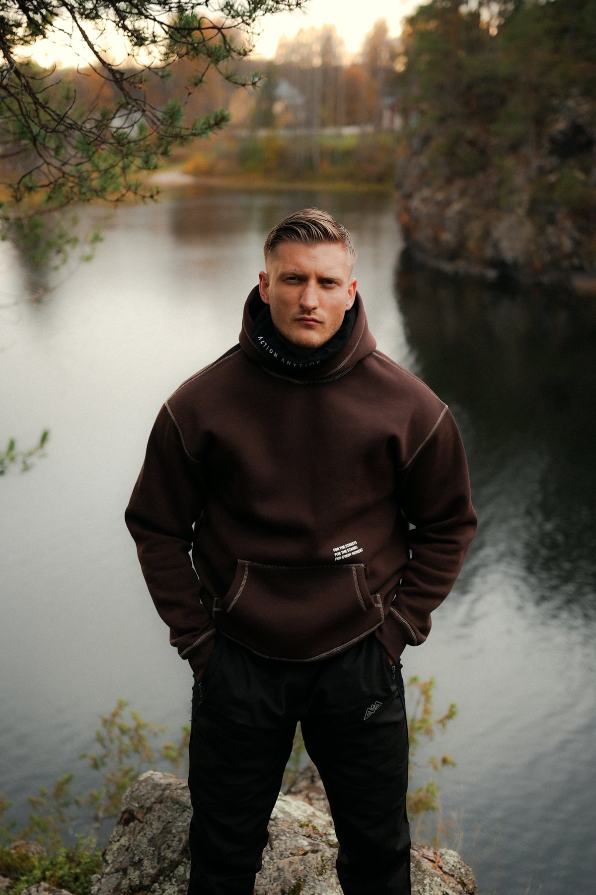 Brown hoodie with raised hood and ACTION ANYTIME print
