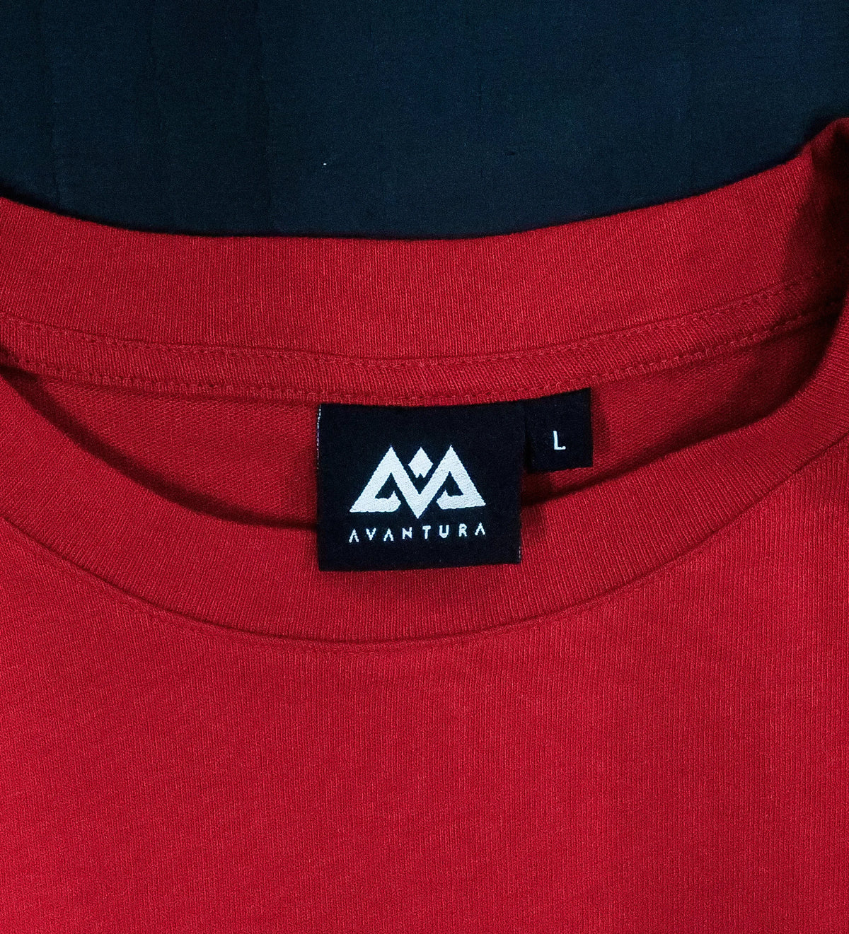 Red t-shirt neckline with black woven Avanta label and size tag