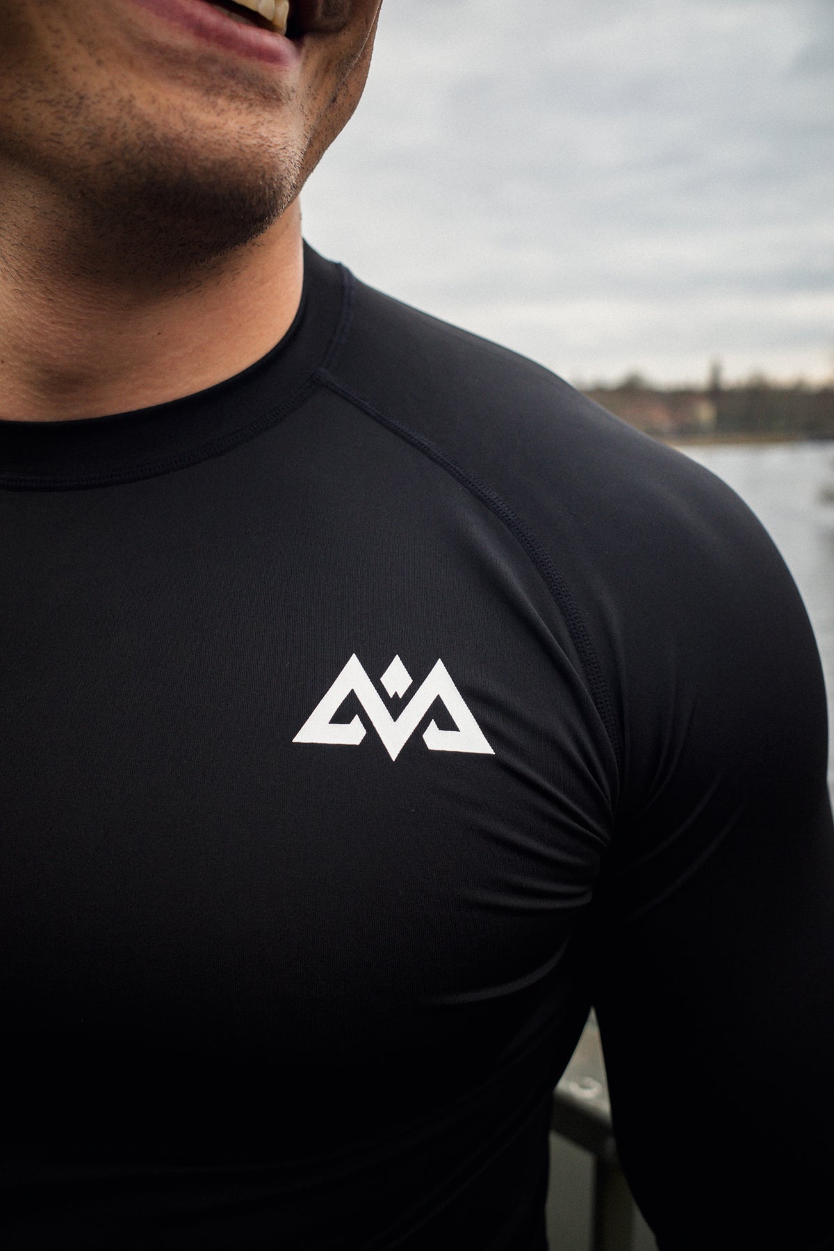 Detail of chest logo and raglan seams on long-sleeve shirt
