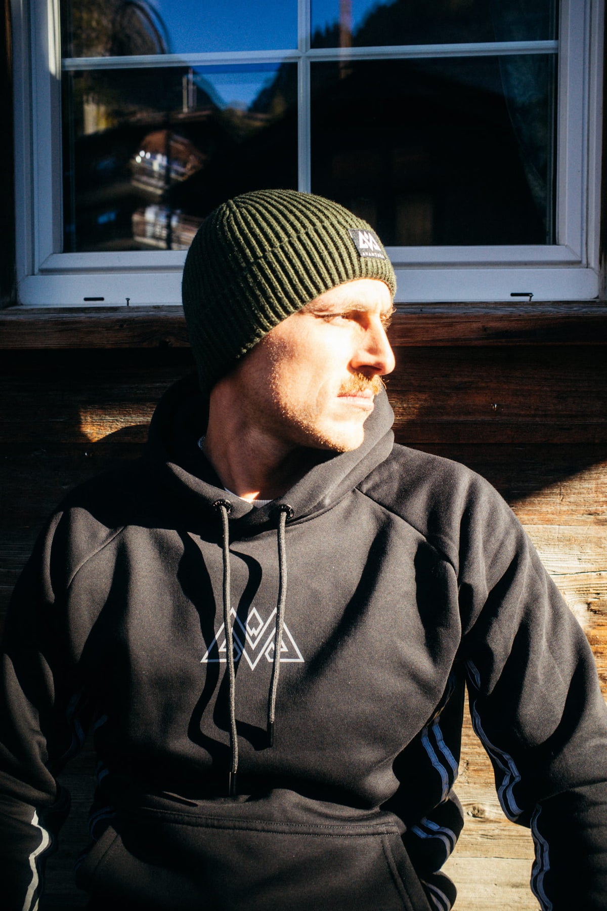 Black hoodie with white geometric logo and dark drawstrings