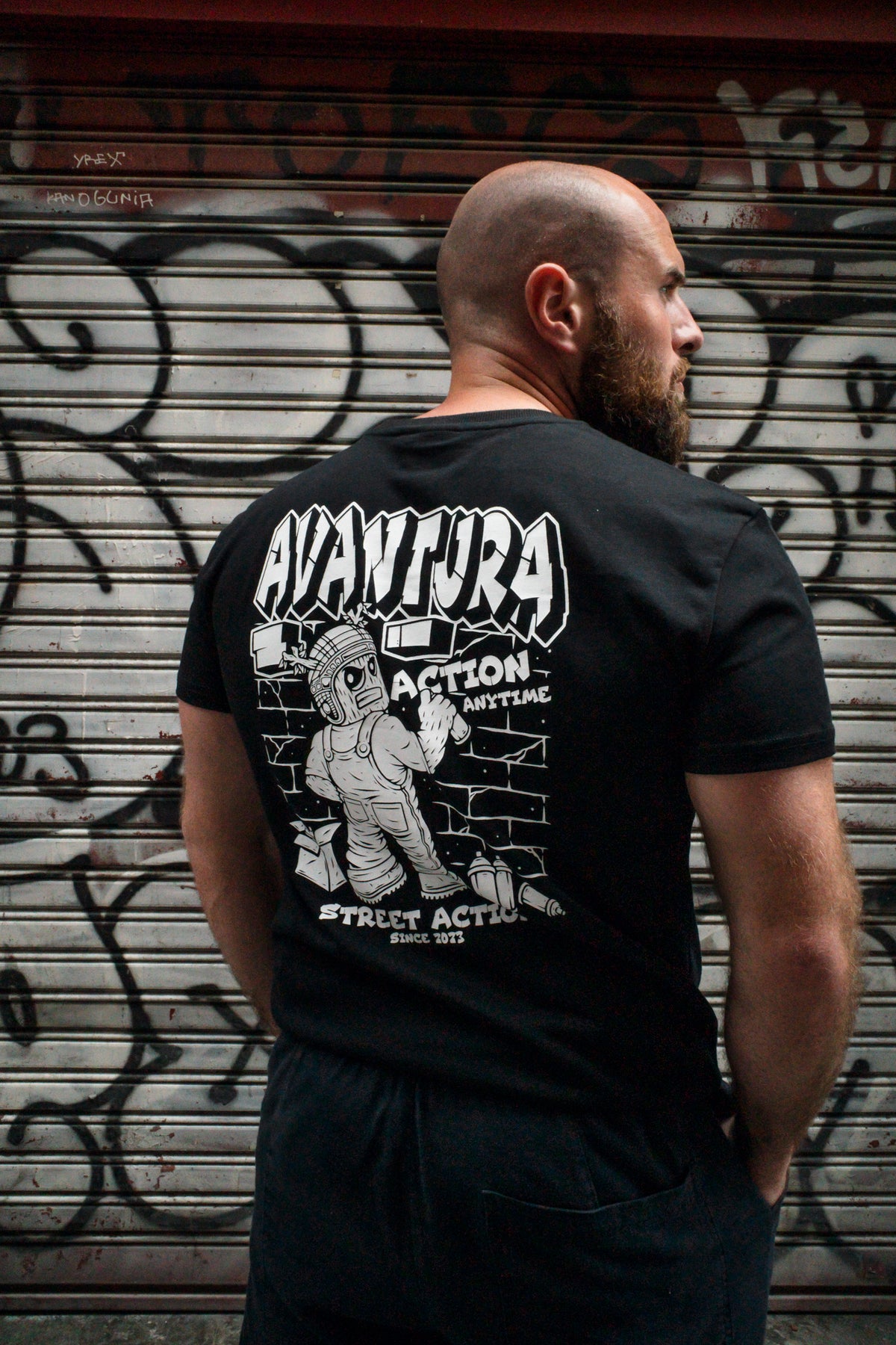 Three-quarter rear view of black T-shirt with full back graphic design