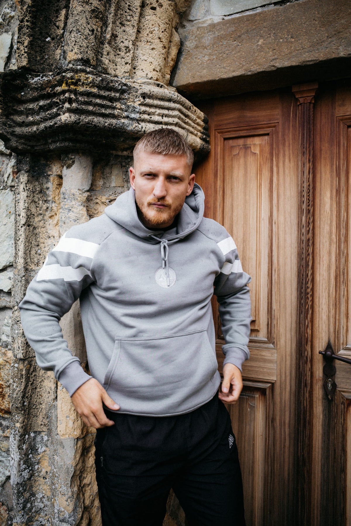Grey striped hoodie with embroidered logo and kangaroo pocket