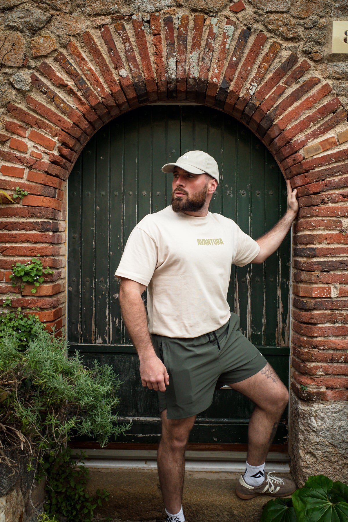 Full body shot emphasizing loose fit of cream oversized crew neck t-shirt