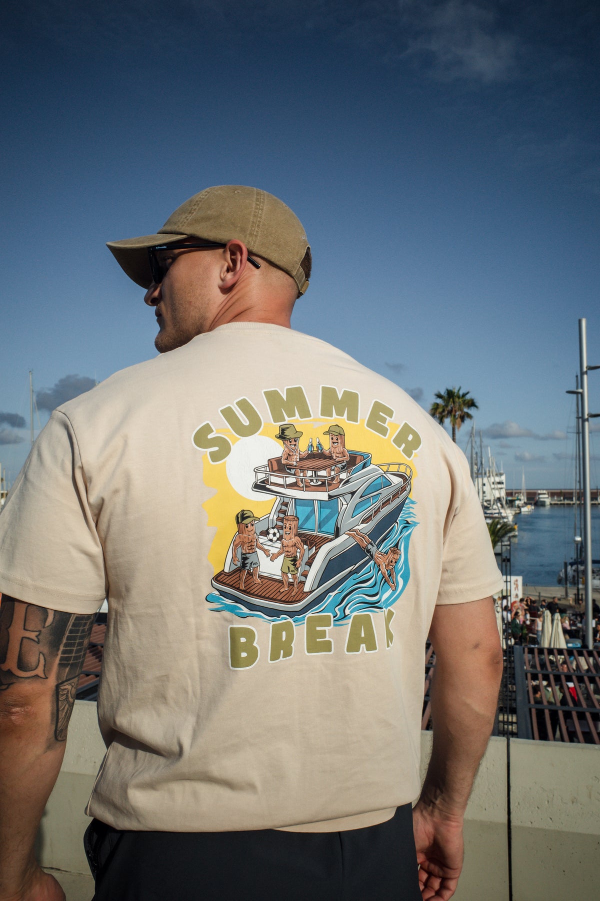 Back view of cream t-shirt featuring large Summer Break yacht graphic