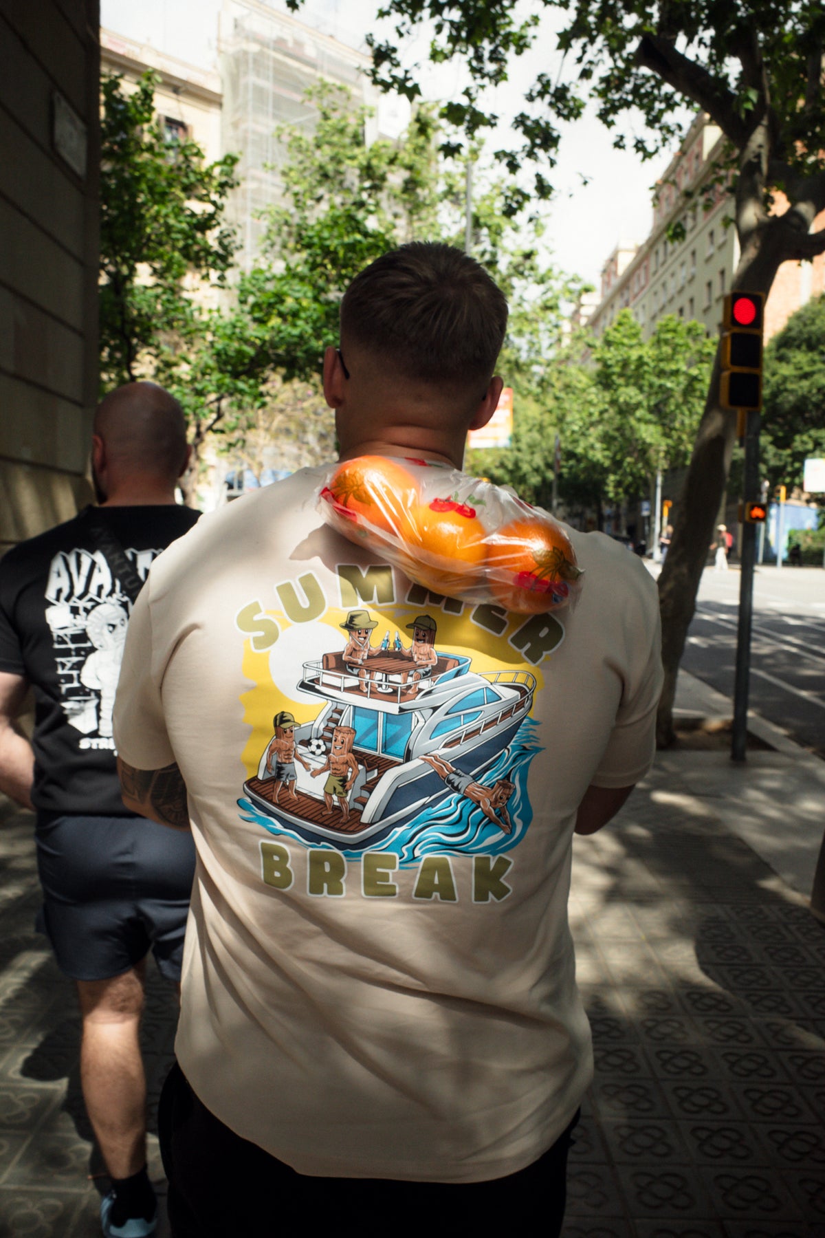 Rear view showing large Summer Break back print on cream t-shirt