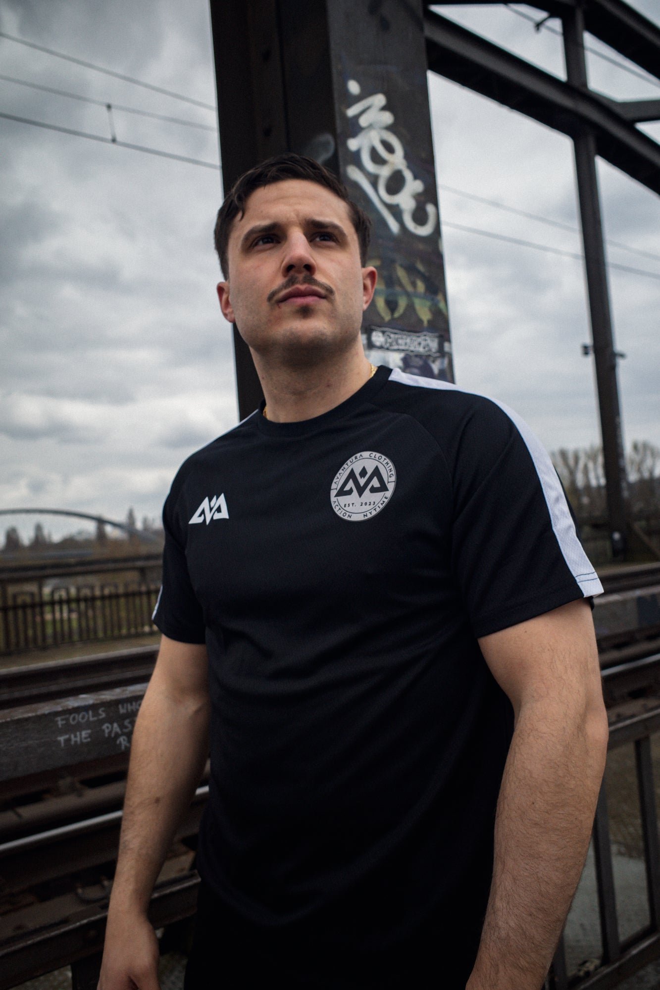 Black performance t-shirt with angular AV logo and circular patch