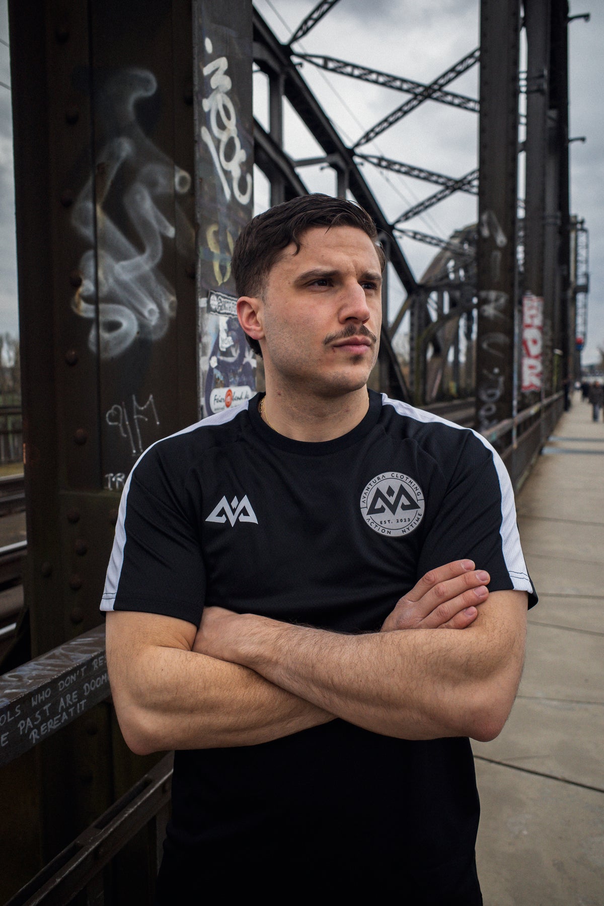 Model wearing black short-sleeved mesh t-shirt with white accents