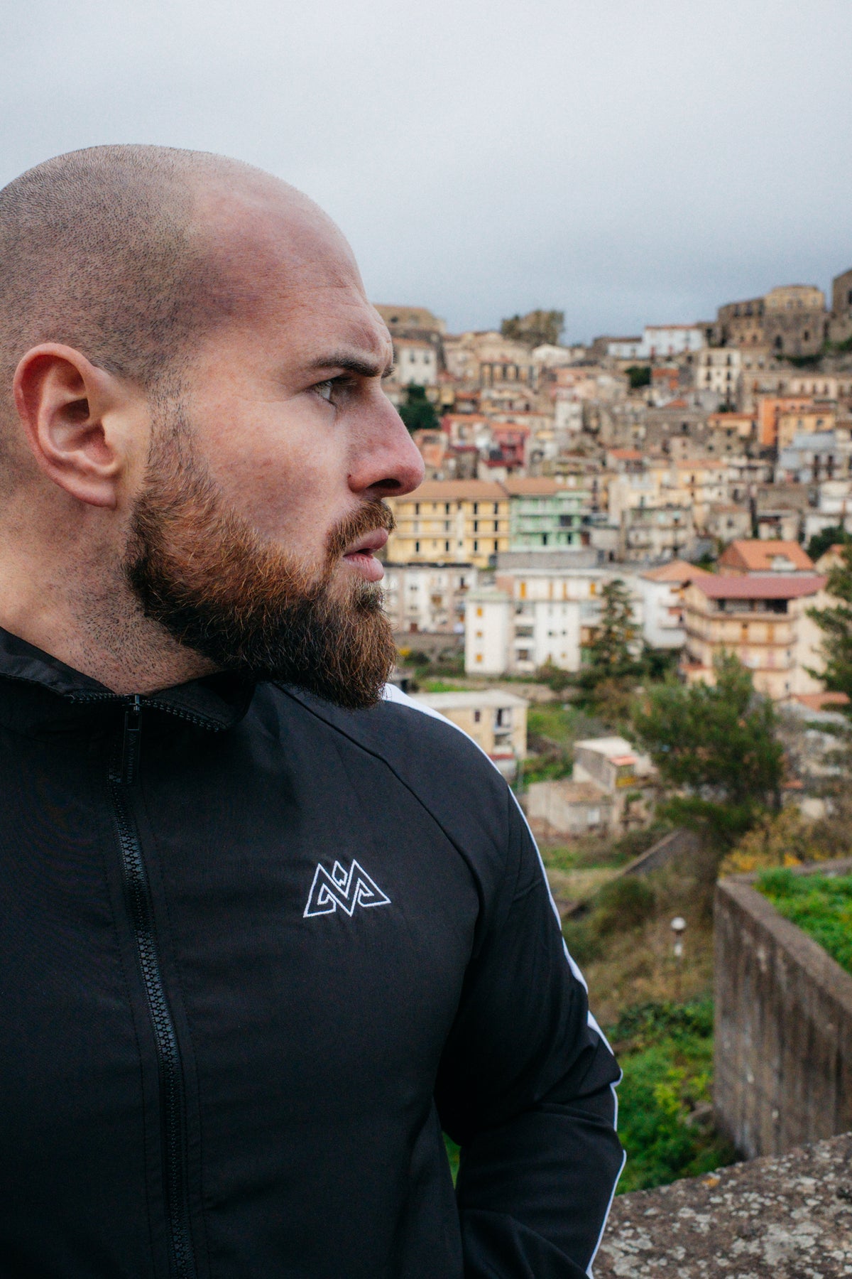 Schwarze Trackjacke mit weißem Logo und Seitenstreifen